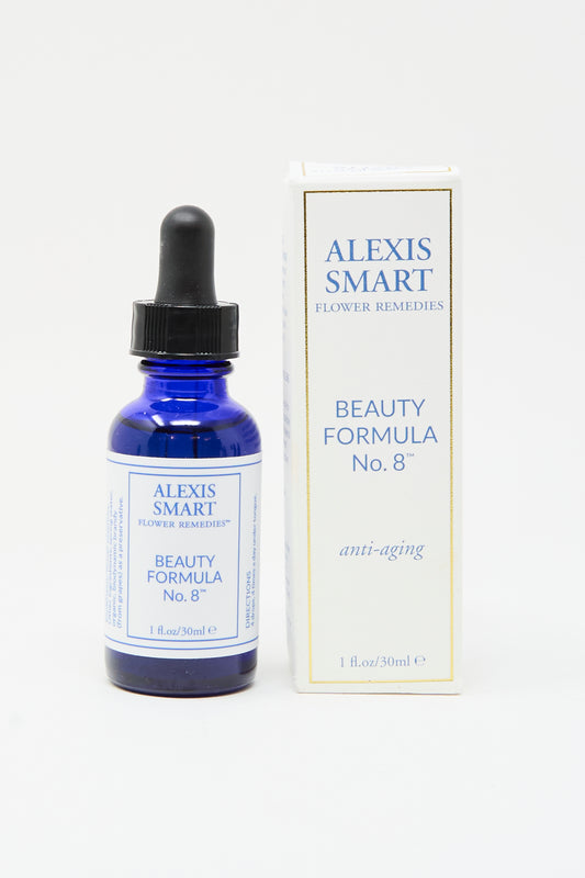 A blue Alexis Smart Flower Remedies - Beauty Formula No. 8 dropper bottle sits beside its white and gold "anti-aging" box, featuring organic flower essences for radiant skin.