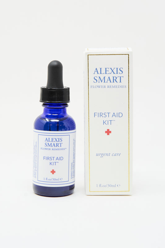 A blue glass dropper bottle labeled "Flower Remedies - First Aid Kit" by Alexis Smart stands beside its white box, both highlighting fast-acting stress relief for urgent care.