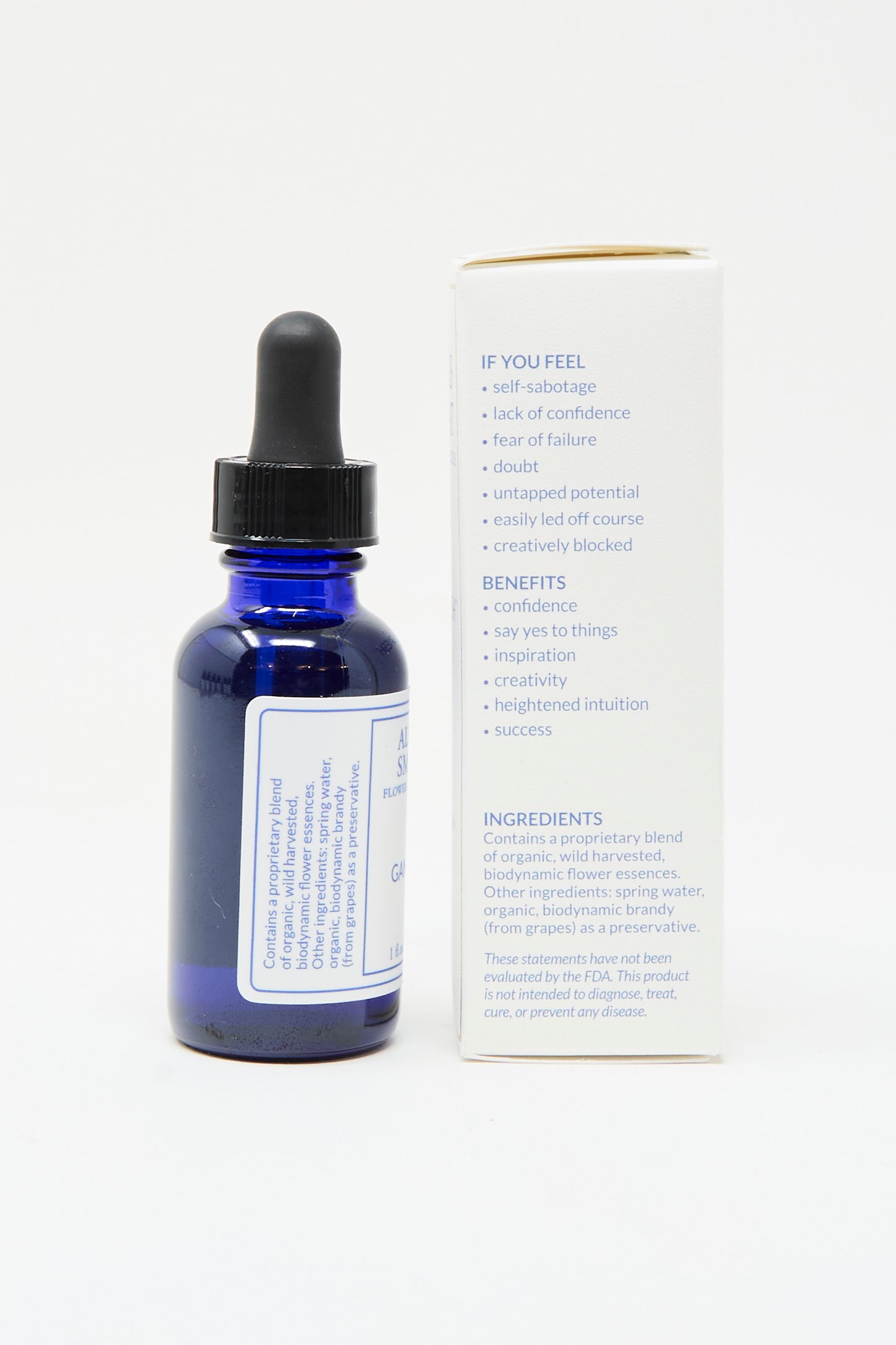 A blue glass dropper bottle of Alexis Smart Flower Remedies - Ganesh stands beside its box, which lists uses, benefits, and organic flower essences for confidence and new beginnings, set against a plain white background.
