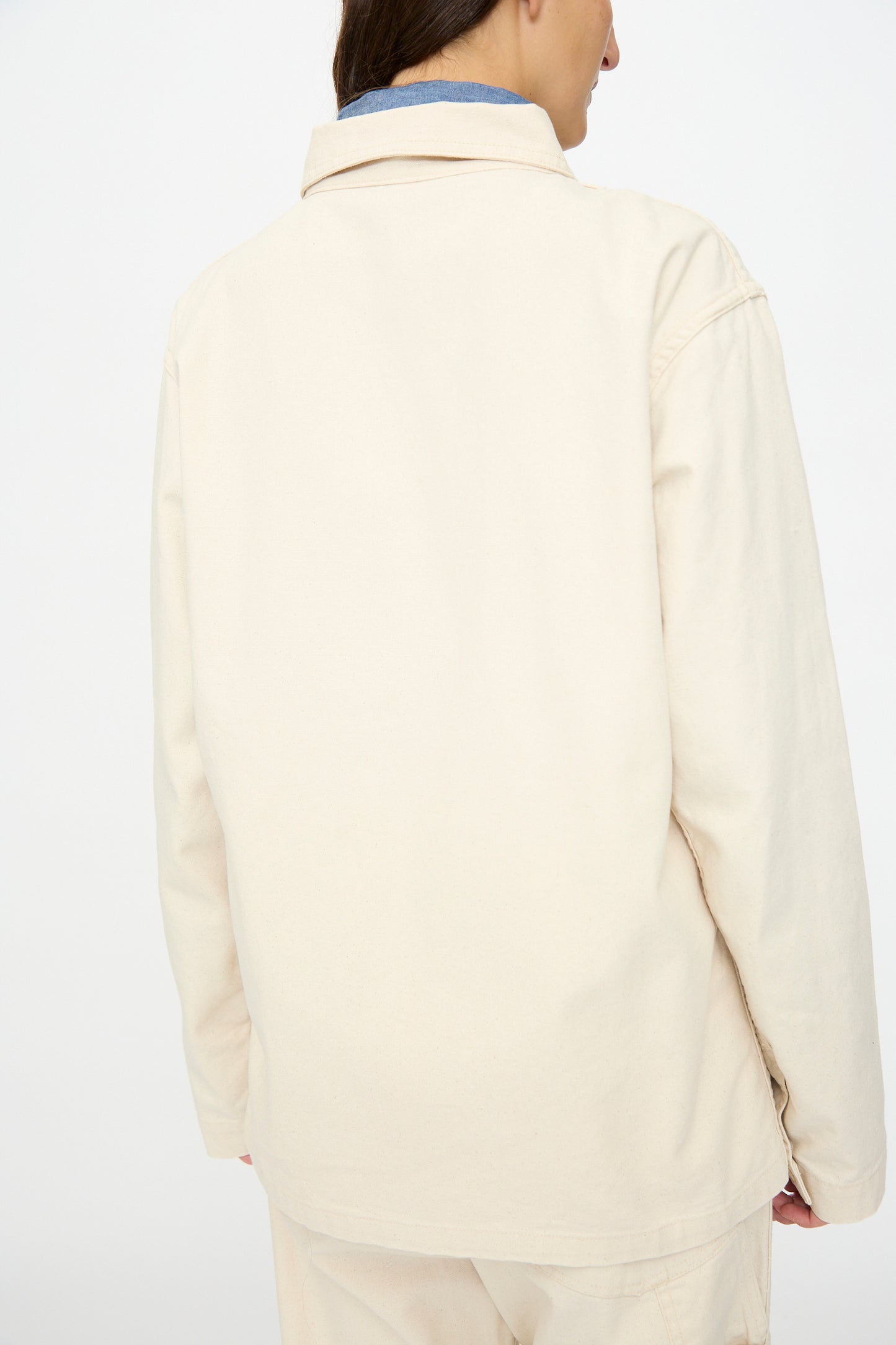 A person is shown from the back wearing the As Ever Henri Jacket in Natural, paired with matching pants, standing against a plain white background.