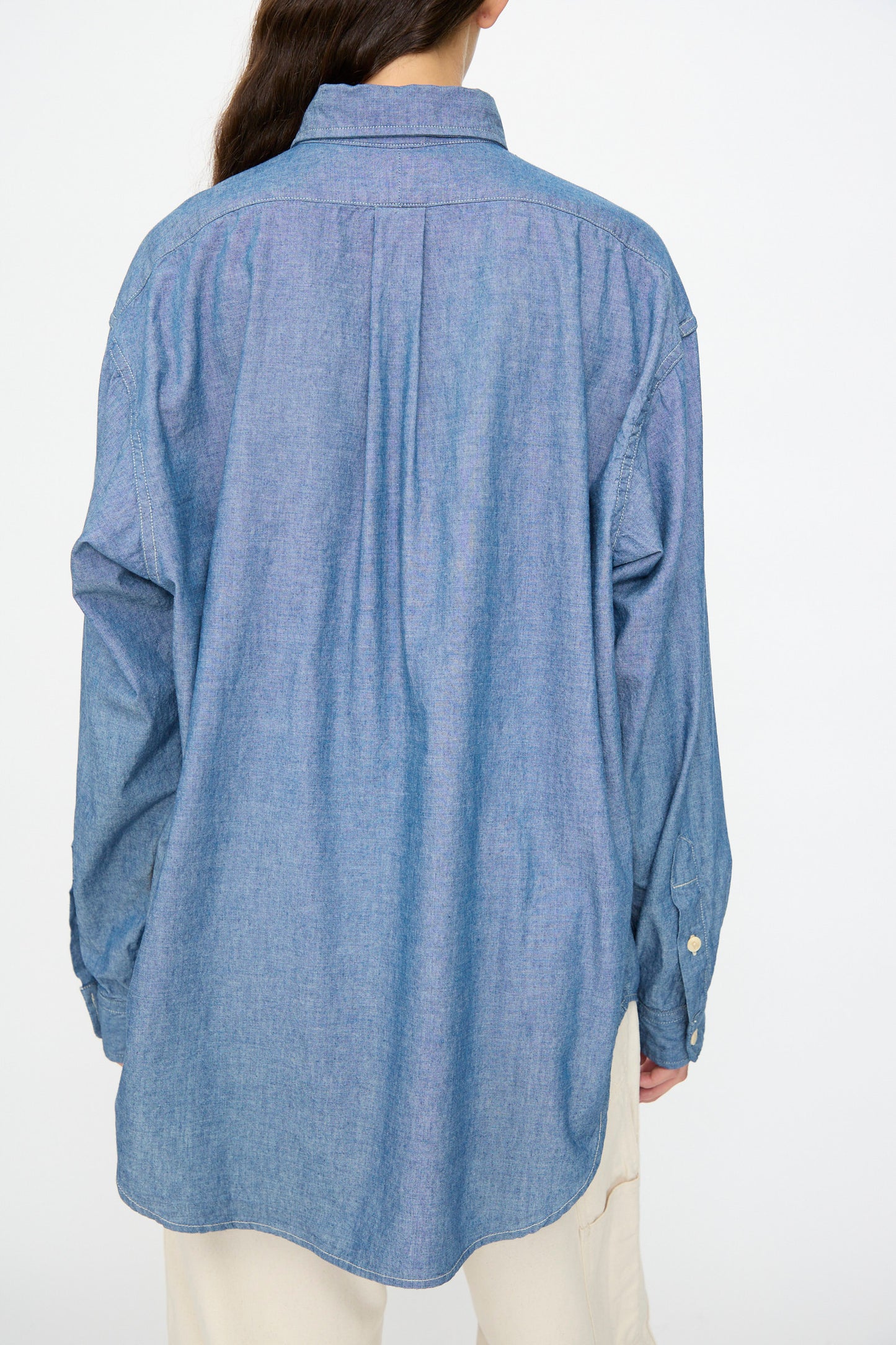Person shown from the back wearing the As Ever Largo Shirt in Chambray paired with cream-colored pants.