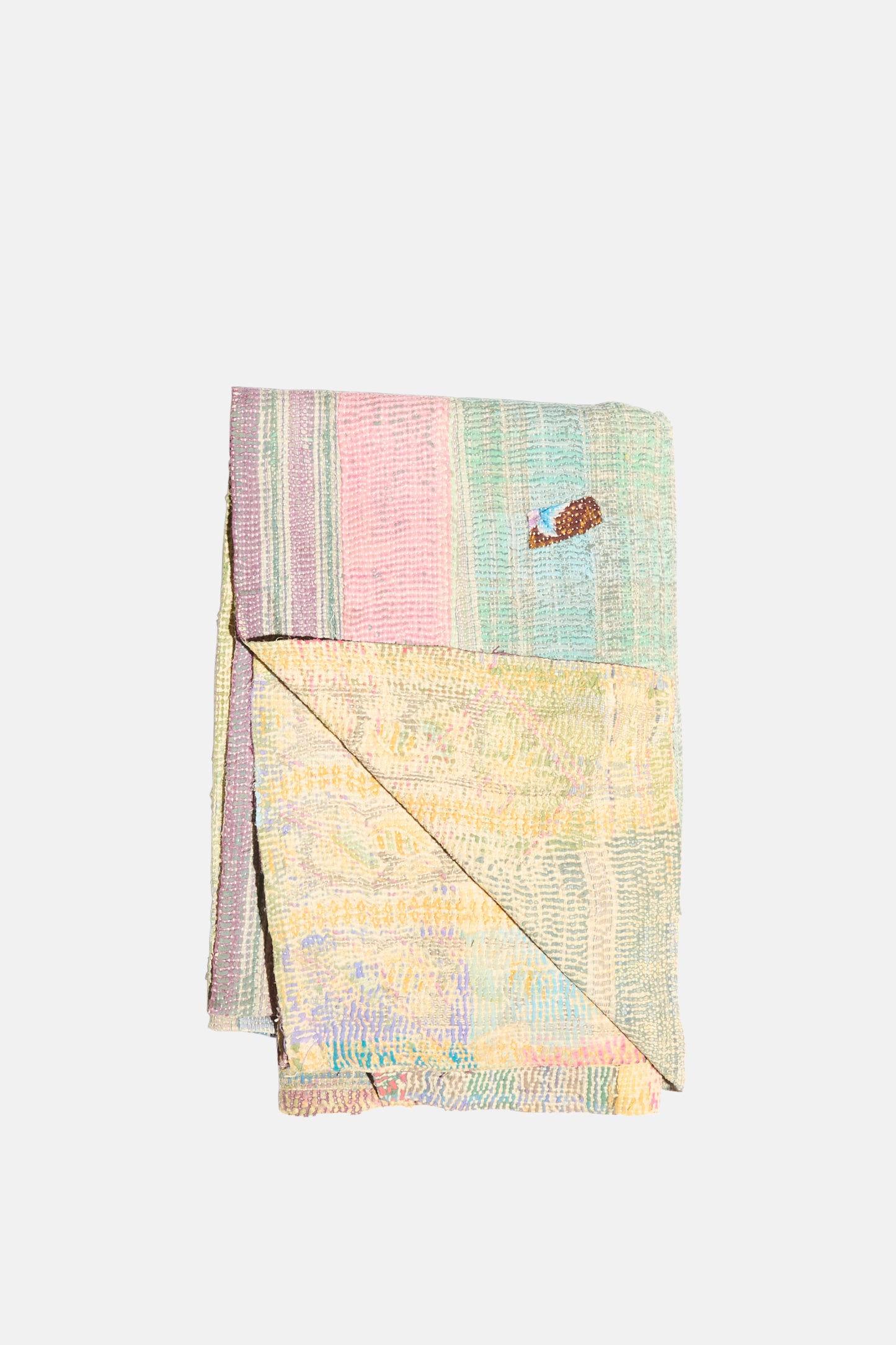 The One of a Kind Vintage Kantha Quilt III by Auntie Oti features vertical pastel patchwork stripes and a small fish patch near the top right, crafted from soft upcycled cotton.