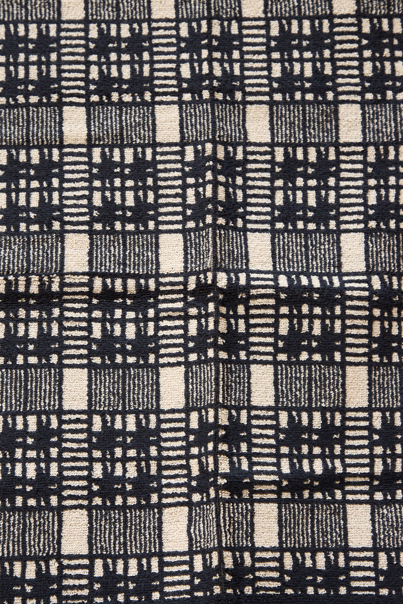 Close-up of a black and white plaid Alma Hand Towel fabric texture from Autumn Sonata.