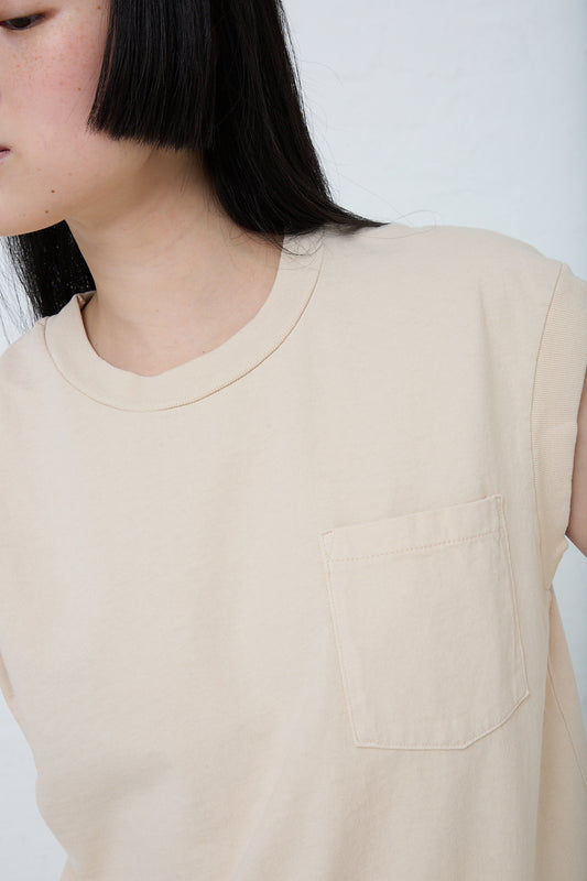 A woman wearing a Pocket Tank in Tan Overdye by B Sides. Front view and up close. 