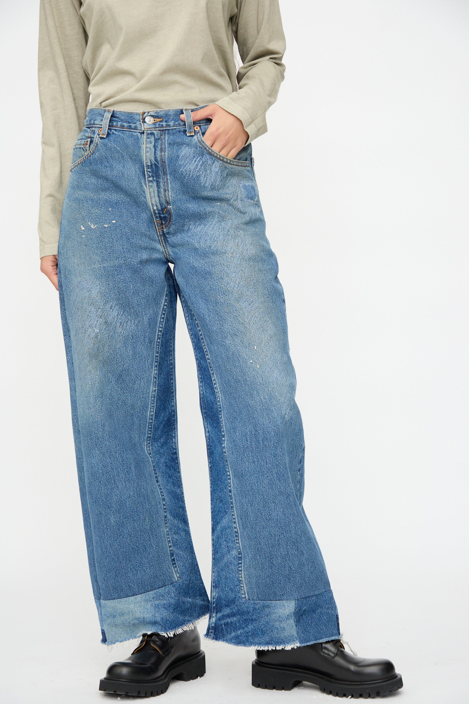 Wearing B Sides Reworked Culotte in Vintage Indigo with a cuffed hem, a light long-sleeve shirt, and black chunky shoes, standing against a plain background.
