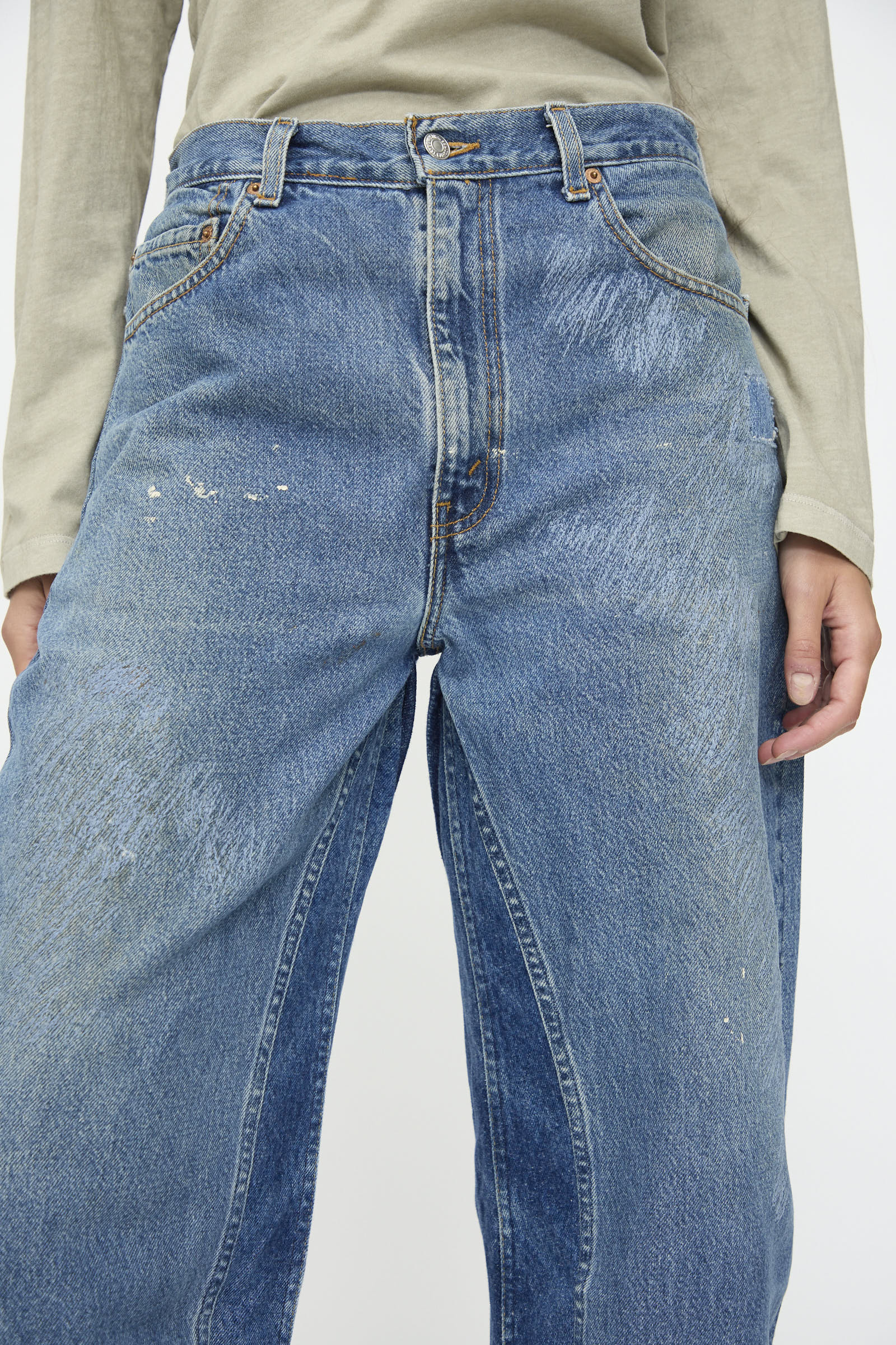 Person wearing the B Sides Reworked Culotte in Vintage Indigo, high-waisted with a button fly and slight fading, paired with a light gray long sleeve shirt. Only the torso and upper legs are visible.