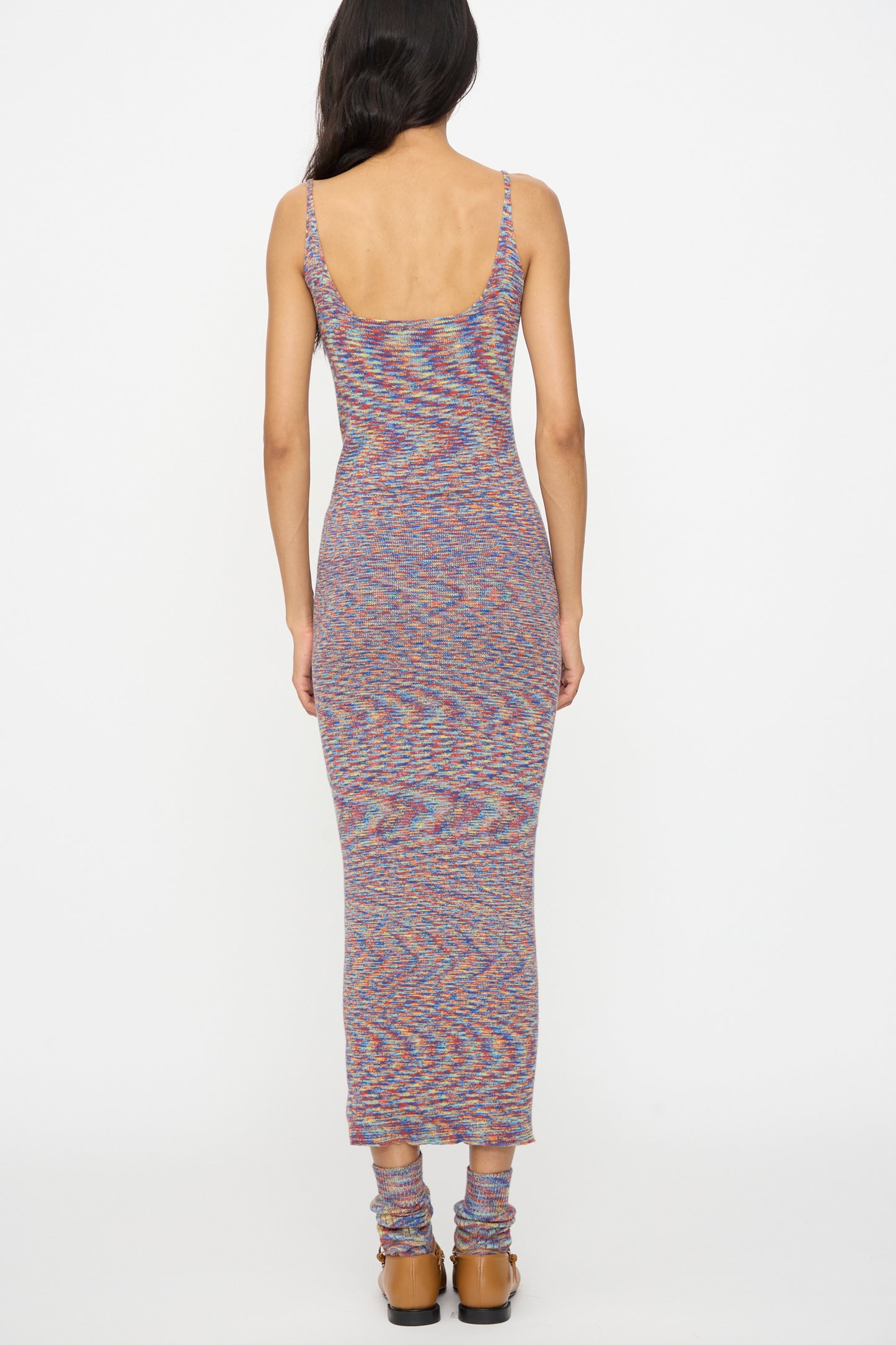 A woman, seen from behind, wears the Baserange Flute Dress in Multicolored with matching leg warmers and brown platform sandals against a plain white background.