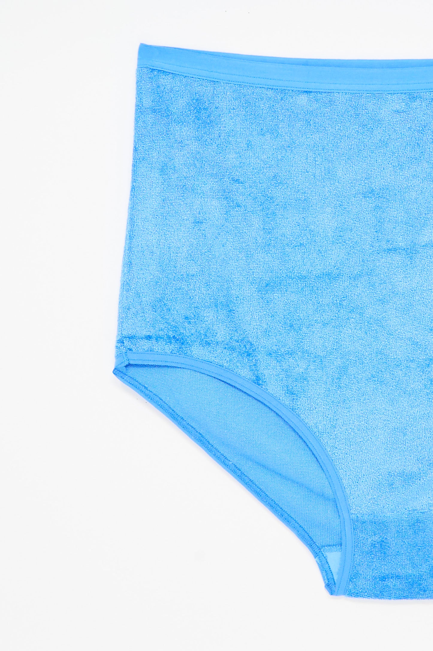 The Baserange Highwaist Bell Pant in Zinn Blue is a pair of high-waisted, light blue terry cloth underpants made from sustainable viscose, shown against a white background.