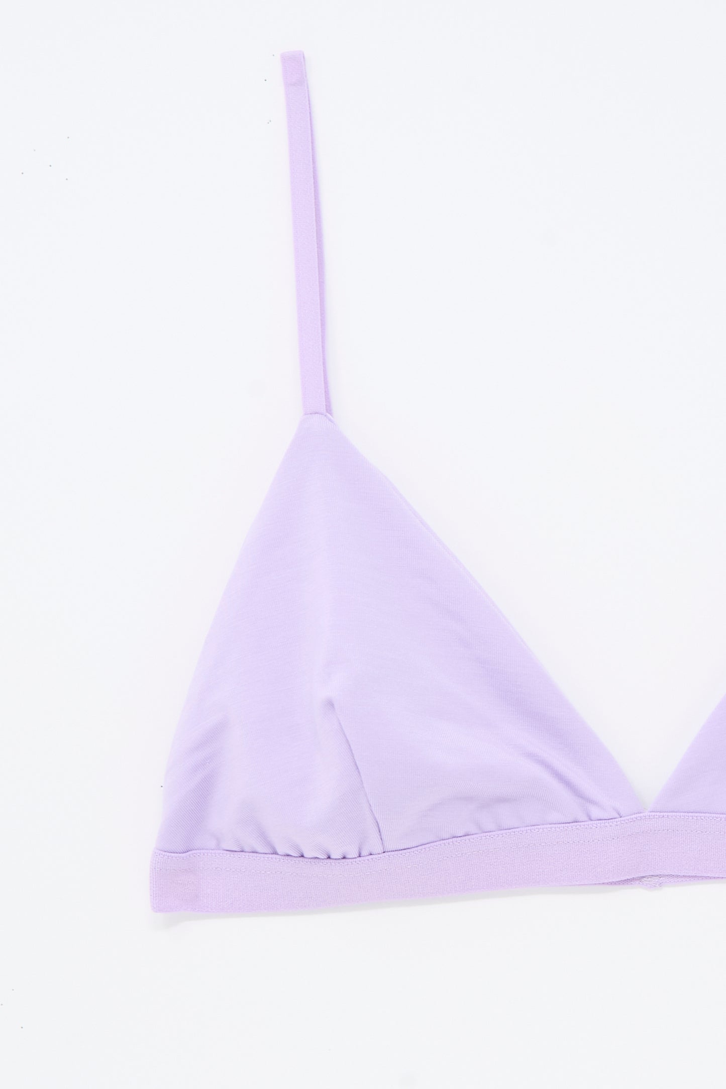 The Baserange Mississippi Bra in One Purple features a lilac triangle bralette design with thin adjustable straps, displayed against a white background. Only the left side of this supportive bra is shown.