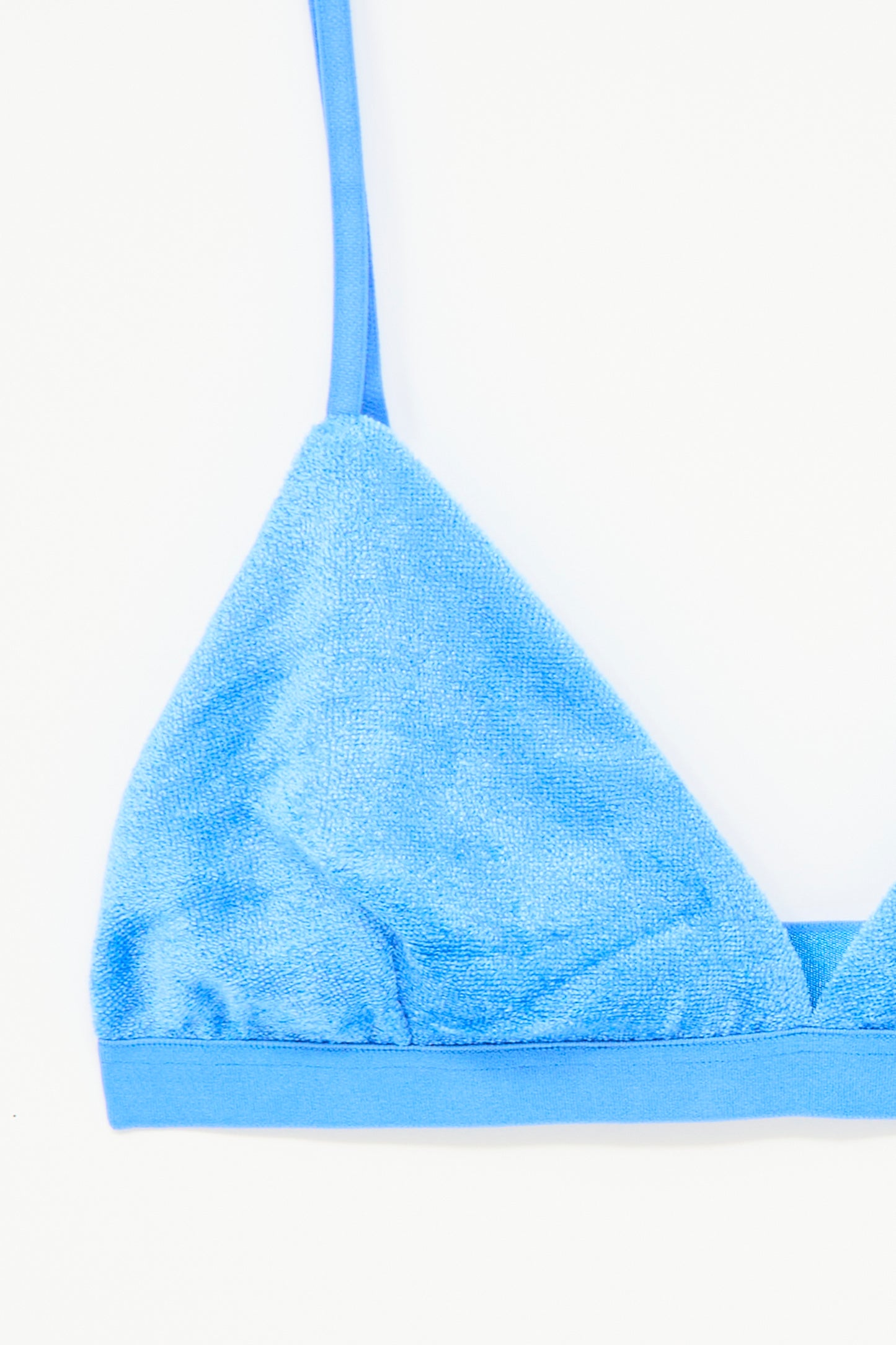 Close-up of the Baserange Mississippi Bra in Zinn Blue, made from terry cloth with adjustable straps, displayed against a white background.