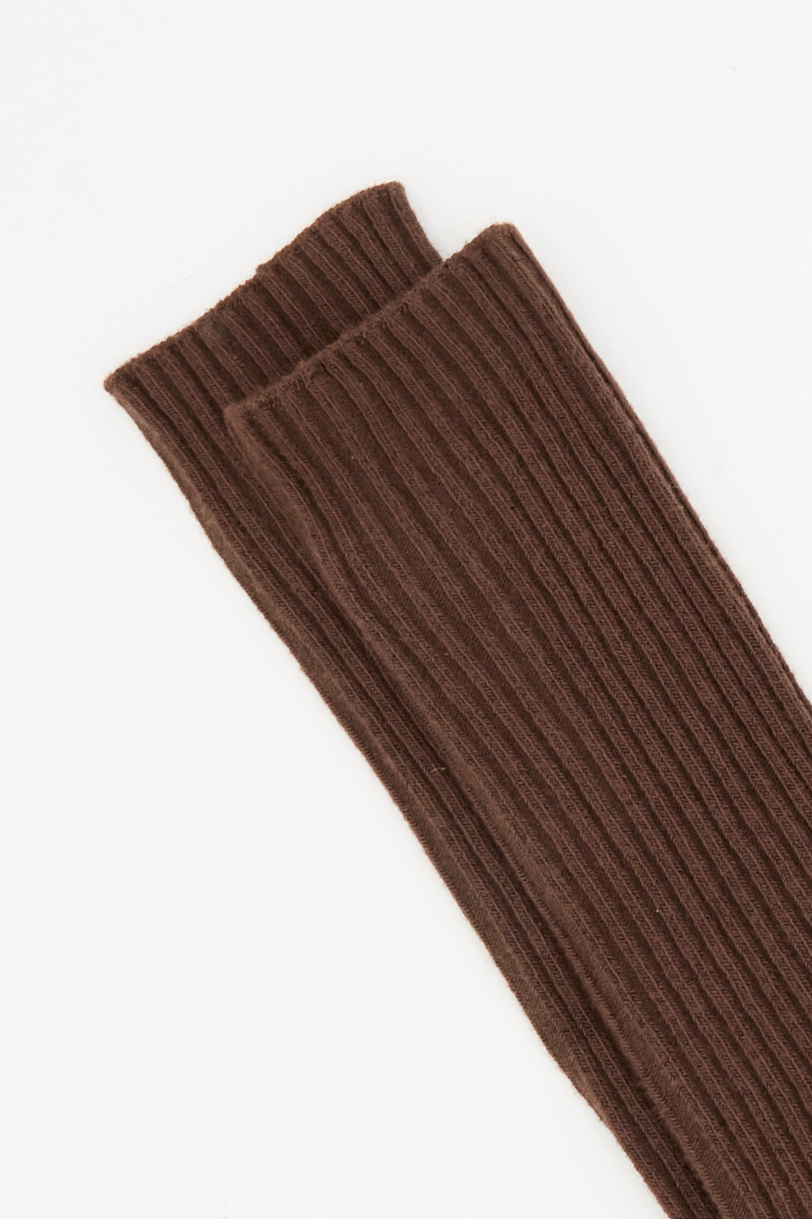 Close-up of two Orta Brown overknee socks by Baserange, featuring ribbed cotton blend knit, laid flat on a white background.