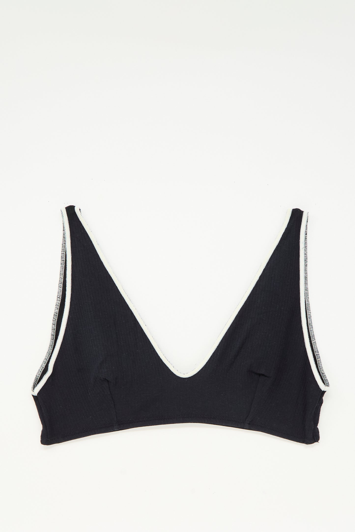 The Baserange Pam Bra in Murano Navy, featuring a v-neck and white trim, is shown laid flat on a white background.