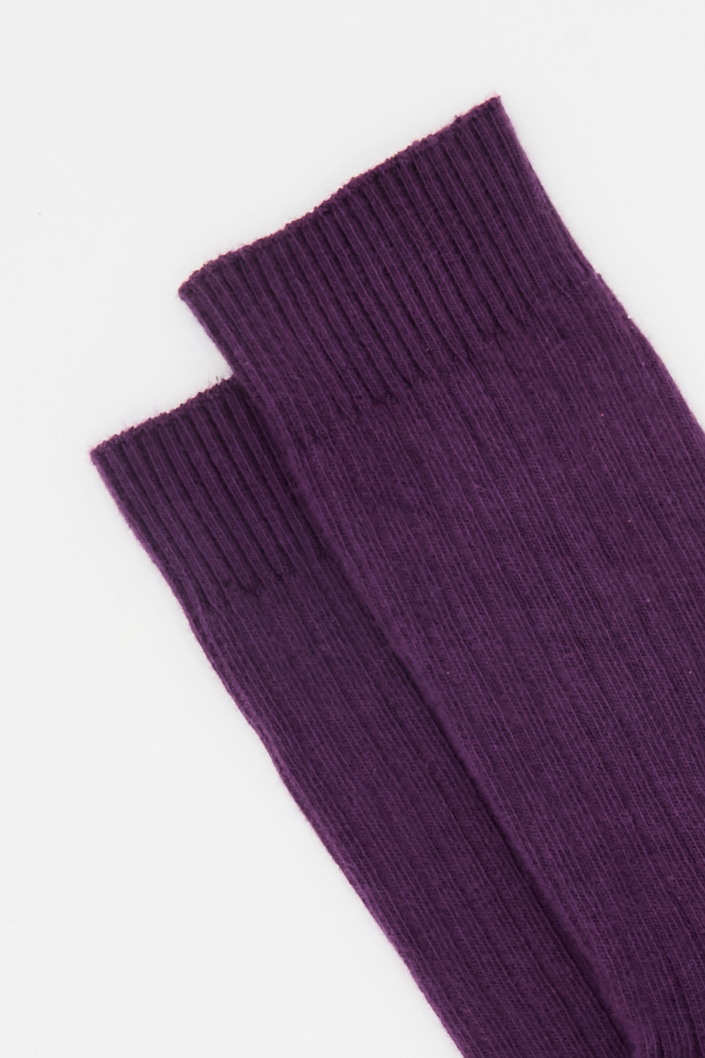 The Baserange Rib Overankle Sock in Gesso Purple, crafted from organic cotton with a ribbed texture, is displayed laid flat on a white background.
