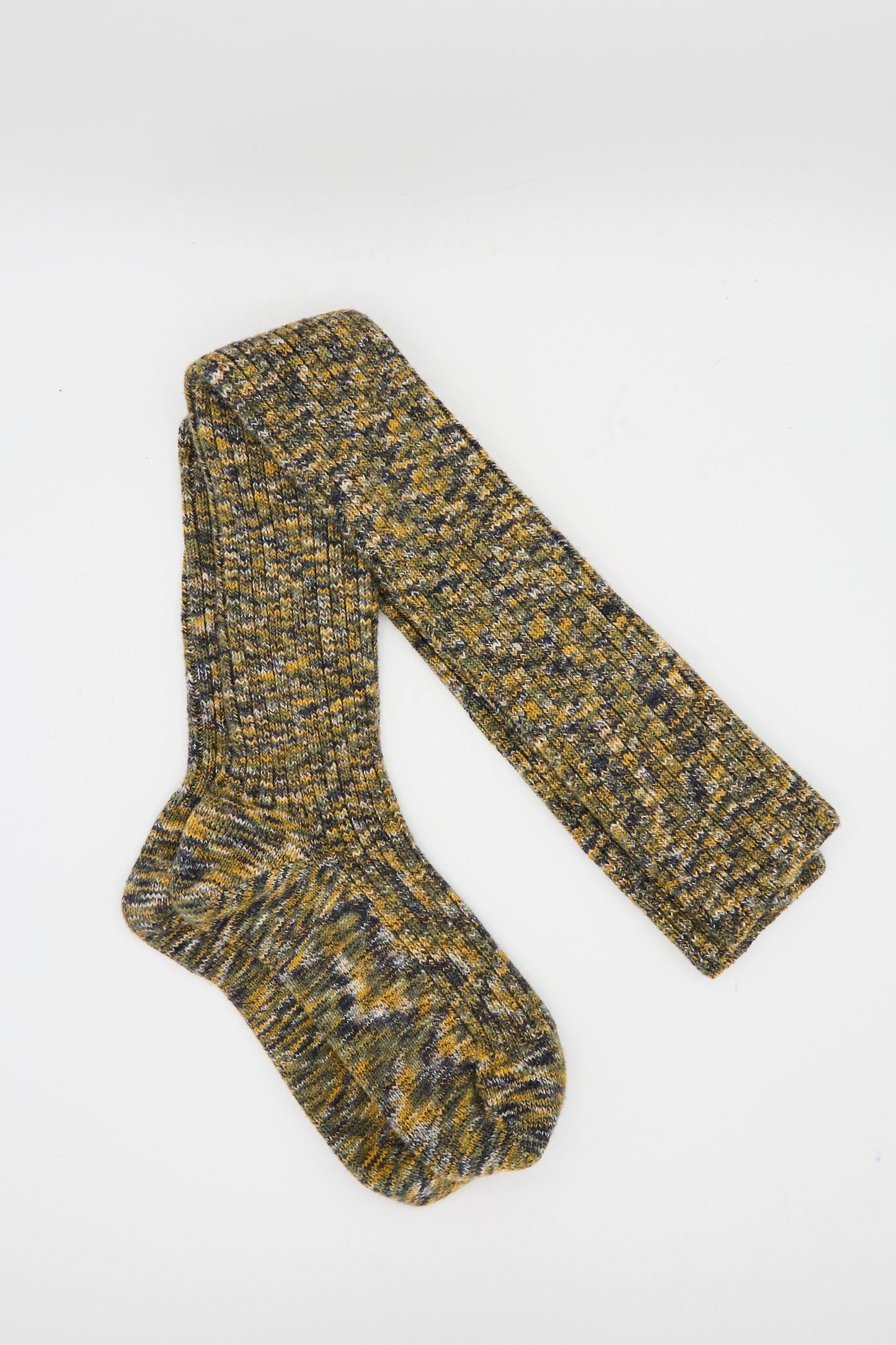 The Baserange Twist Overknee Sock in Olive Green Melange features a long, rib knit design with yellow, green, and gray tones. Made in France, these knee-high socks are shown on a white background.