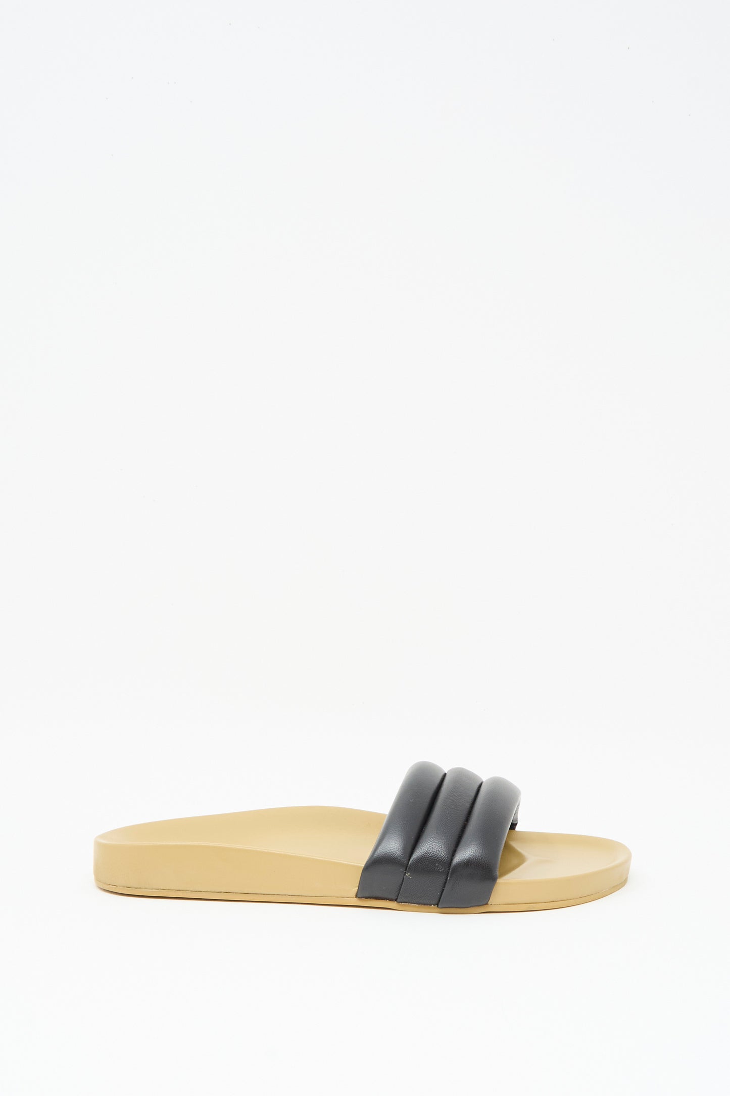 The Classic Sandalia in Black by Beatrice Valenzuela features black, padded lambskin double straps and a beige leather flat sole, shown against a white background.