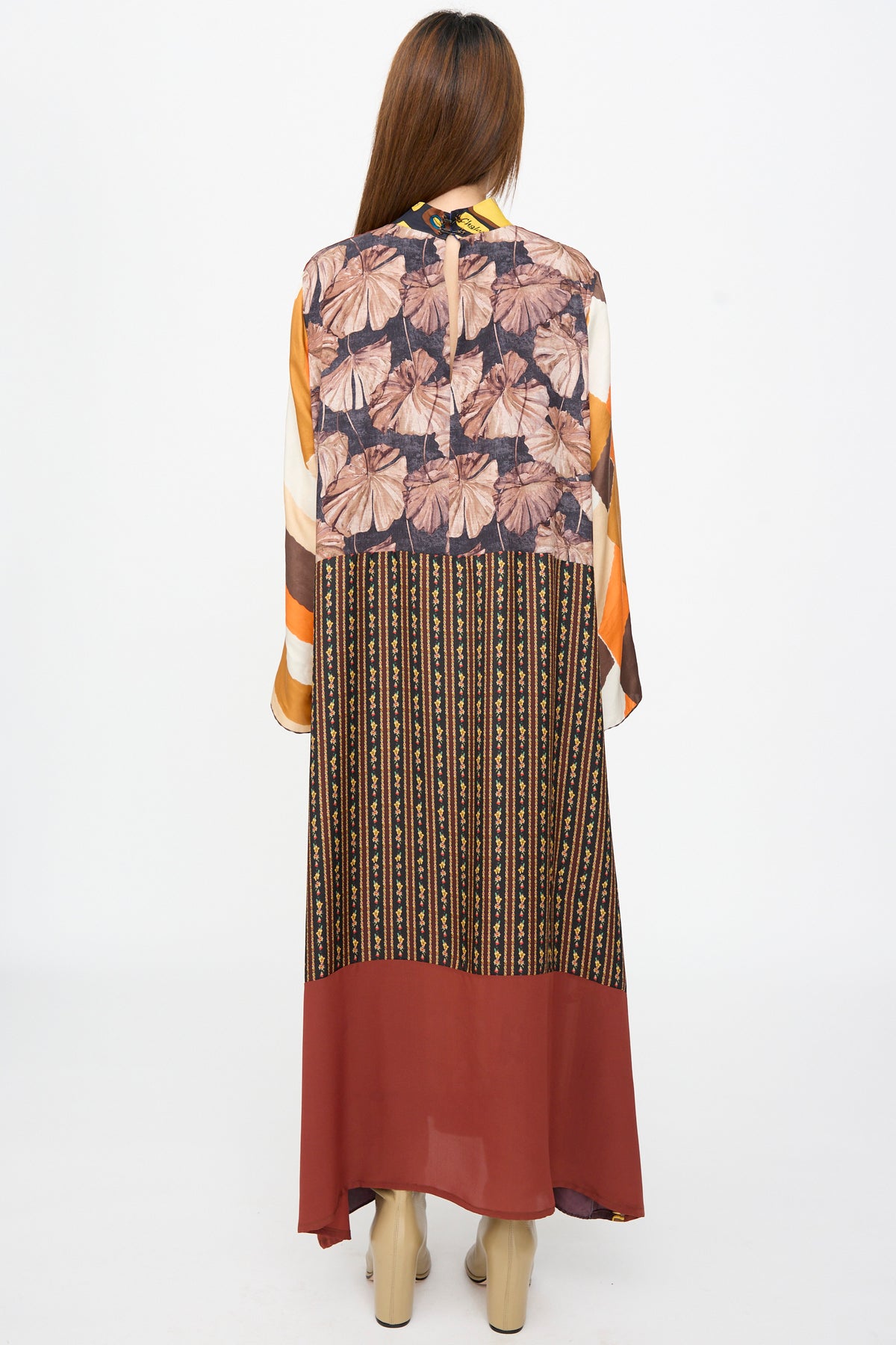 Back view of the Bettina Bakdal Classic Mandarin Collar Dress in Benita Otte, a long-sleeved midi dress featuring floral, striped, and solid panels in brown, orange, and cream.
