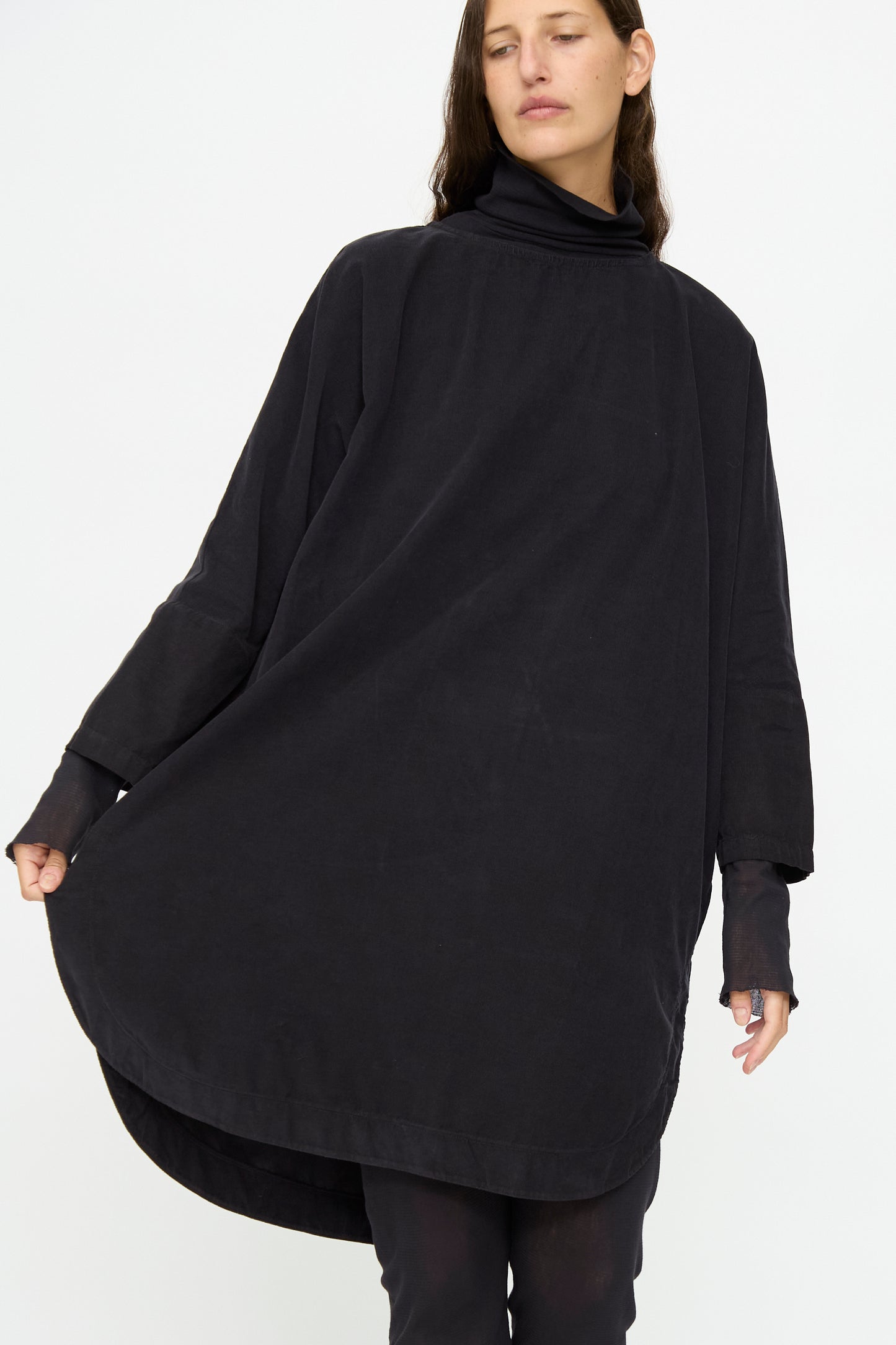 A person wearing the Black Crane Painter Dress in Dark Navy stands against a plain white background.