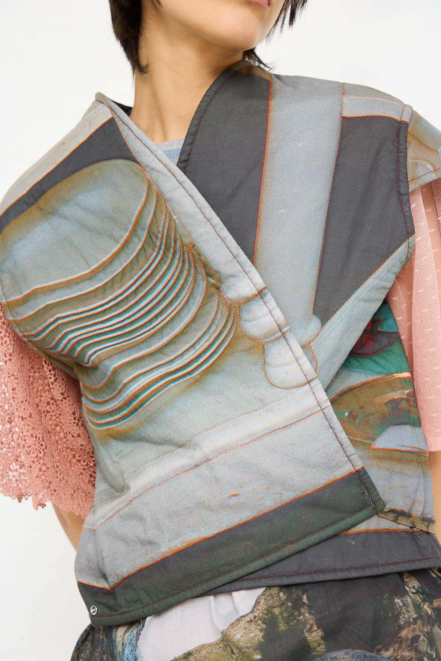 Woman wearing a Bless Cotton No. 77 Summer Living Vest in Print with layered fabric details over a multi-colored blouse.