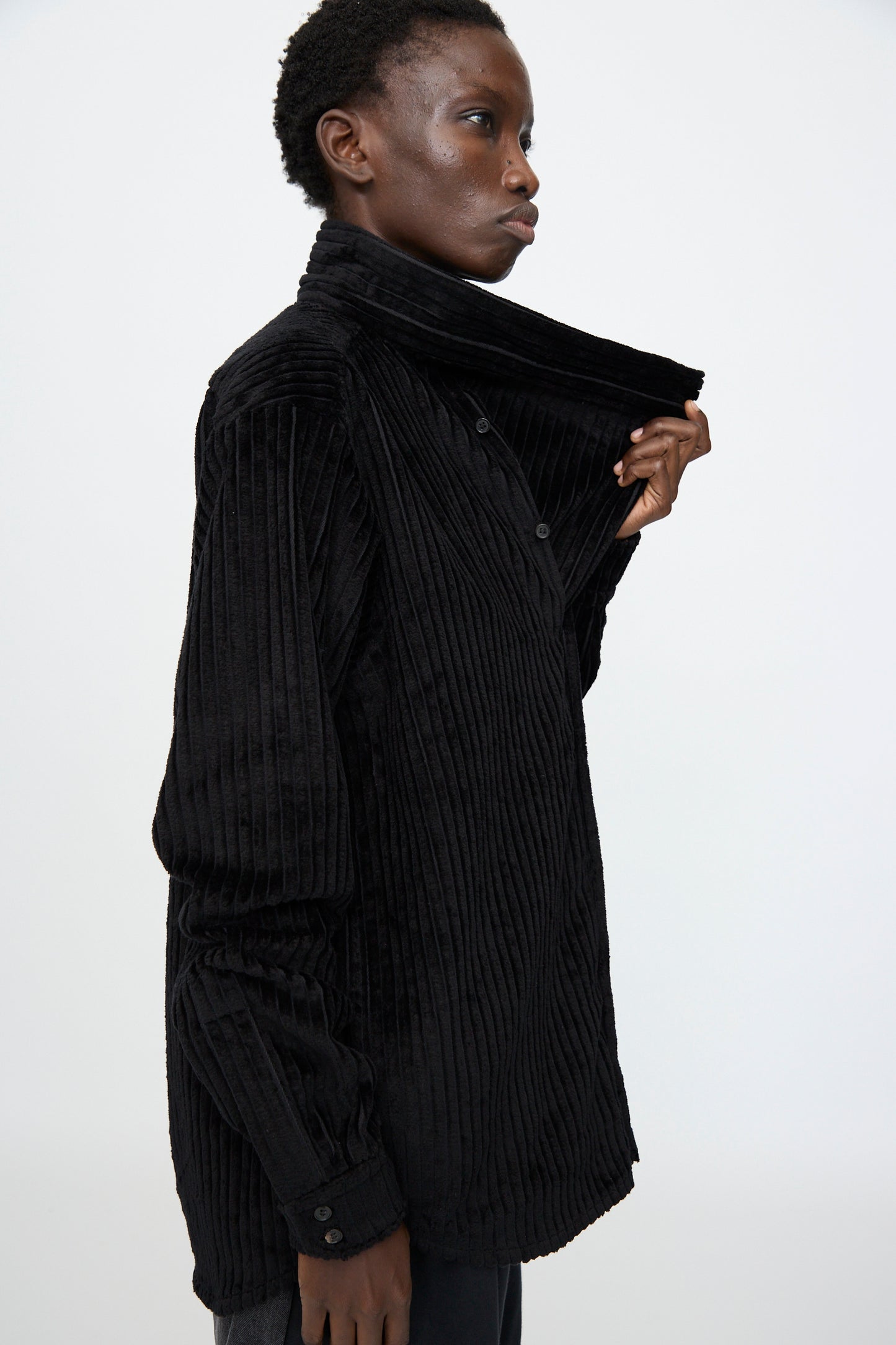 A man wears the Bless No. 68 Neckerchiefer in black corduroy.