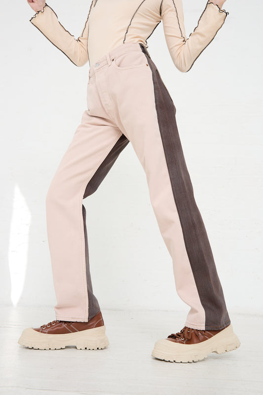 Person standing in Bless No. 73 Jeanspleatfront in Pink/Brown with a contrasting dark side stripe and cream shoes.