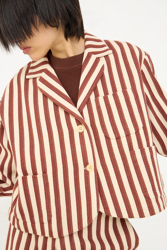 Person in a Caron Callahan Bernay Jacket in Auburn Stripe with a brown turtleneck sweater.
