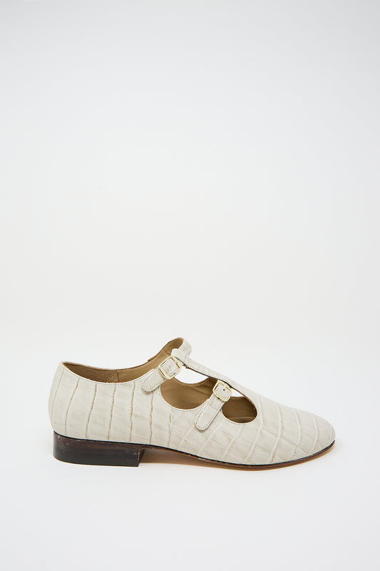 Alfie Flat in Ivory Embossed Leather shoe with a low heel against a white background.