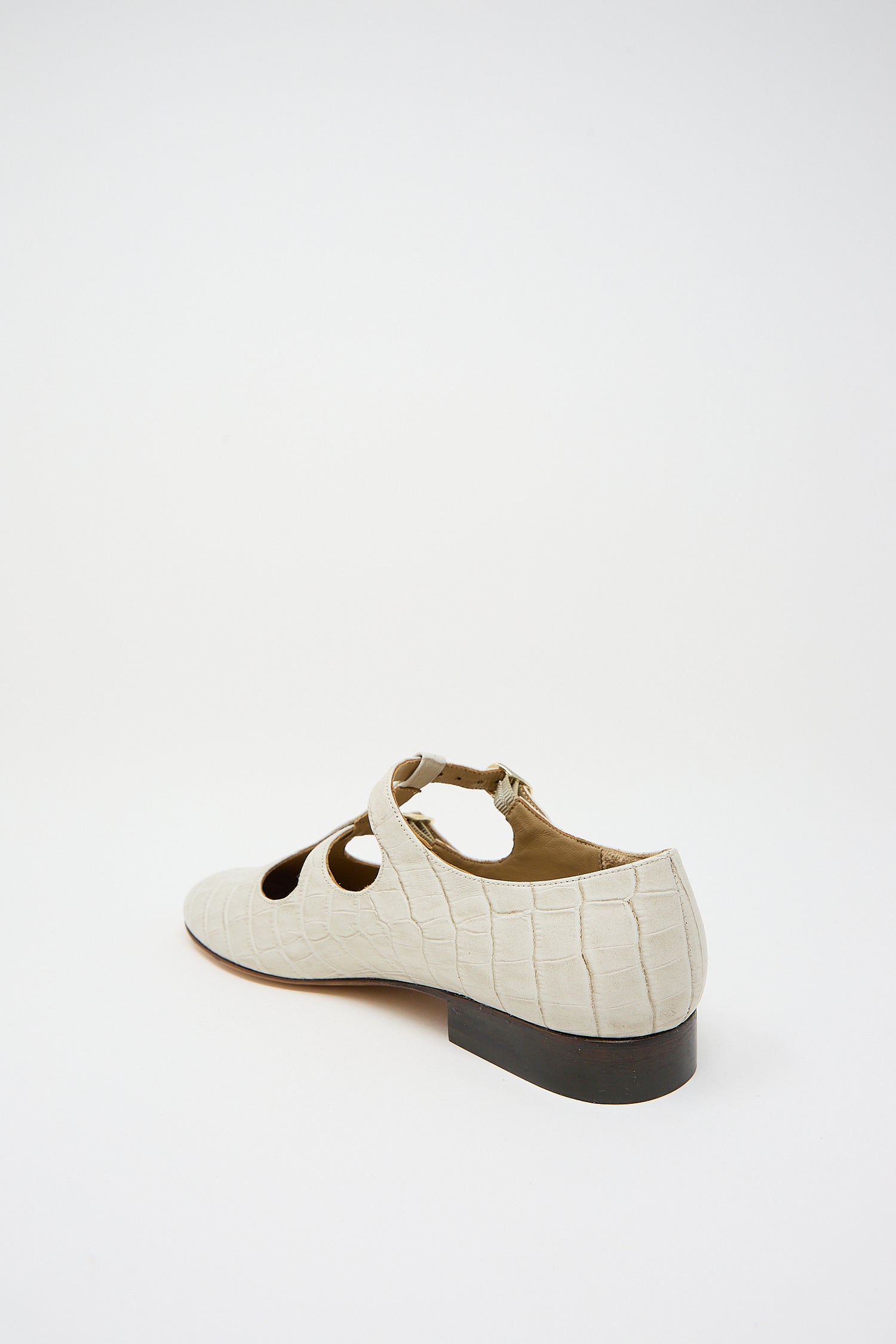 A single Alfie Flat in Ivory Embossed Leather shoe by Caron Callahan against a plain background.