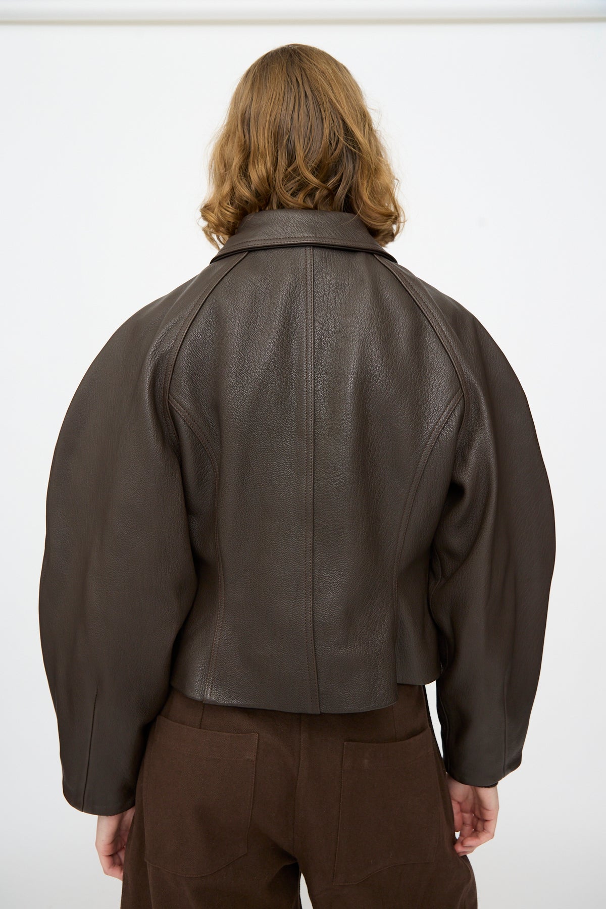 Person with shoulder-length light brown hair wearing the Cawley Leather Heidi Boned Jacket in Brown, photographed from behind against a plain white background.