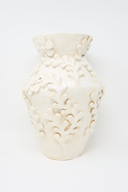 The Le Jardin Blanc Tall Amphora Vase by Clandestine is a white textured ceramic piece with raised floral and leaf patterns, photographed against a plain white background.