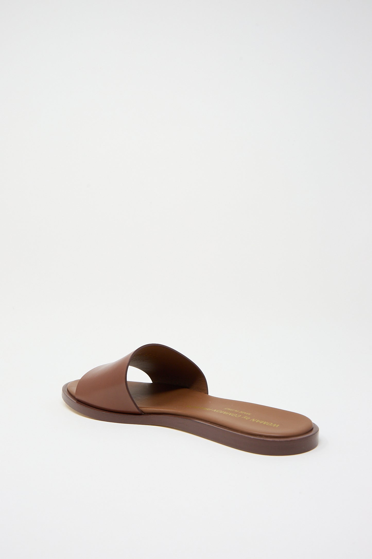Luxury footwear: Common Projects Leather Slide 6155 Sandal in Brown on a white background.