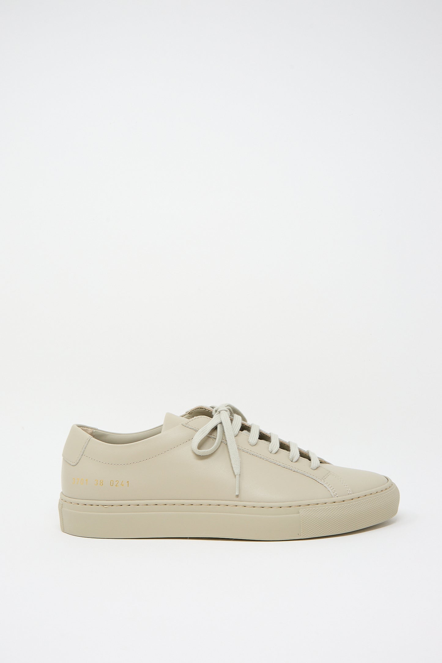 A single taupe Original Achilles Low 3701 sneaker from Common Projects, positioned against a white background.