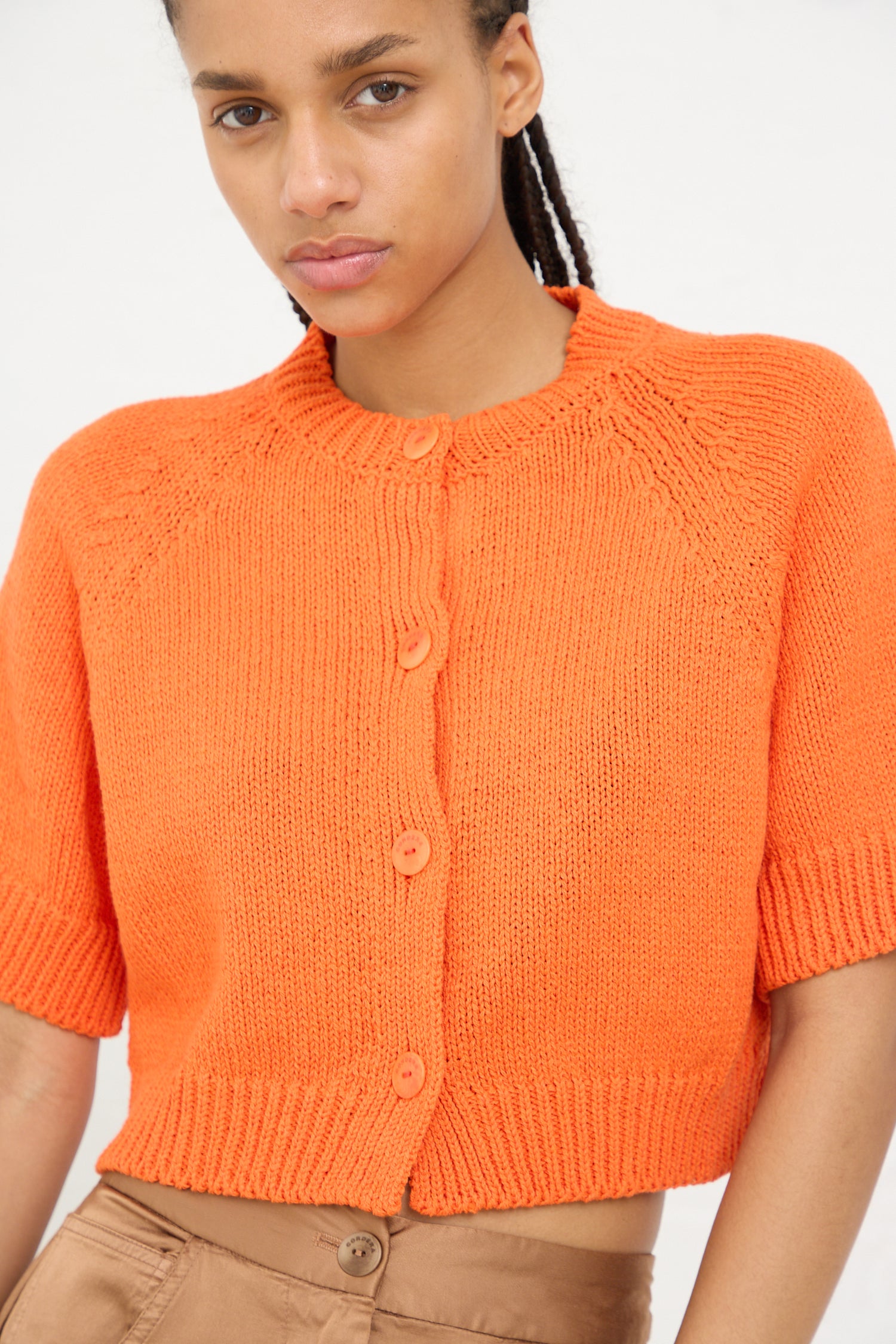 Woman wearing a Cordera Cotton Knit Buttoned Top in Mandarina.
