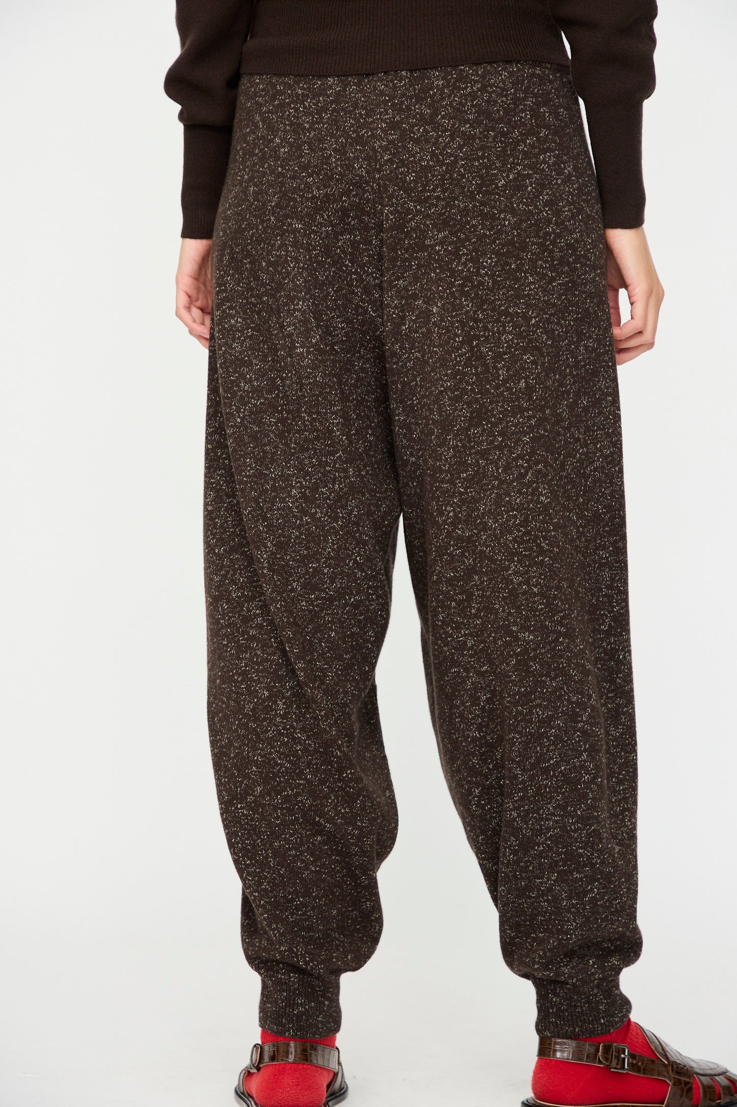 A person wears the Cordera Flecked Cotton Pant in Brown with red sandals, standing against a plain white background.