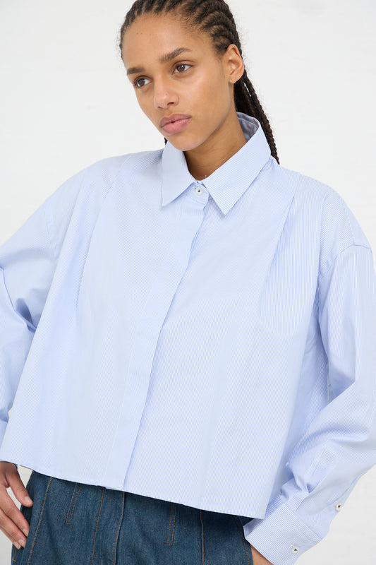 Woman wearing an oversized fit blue striped Cordera Organic Oxford Shirt made in Spain with a hand in pocket.