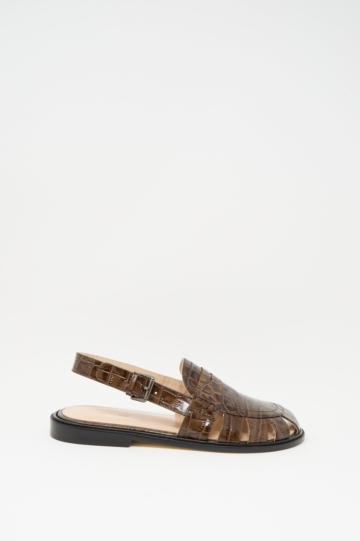 The Cordera Slingback Loafer in Crocodile features a brown crocodile-textured finish, closed toe, open sides, and a side buckle strap. Photographed against a plain white background.