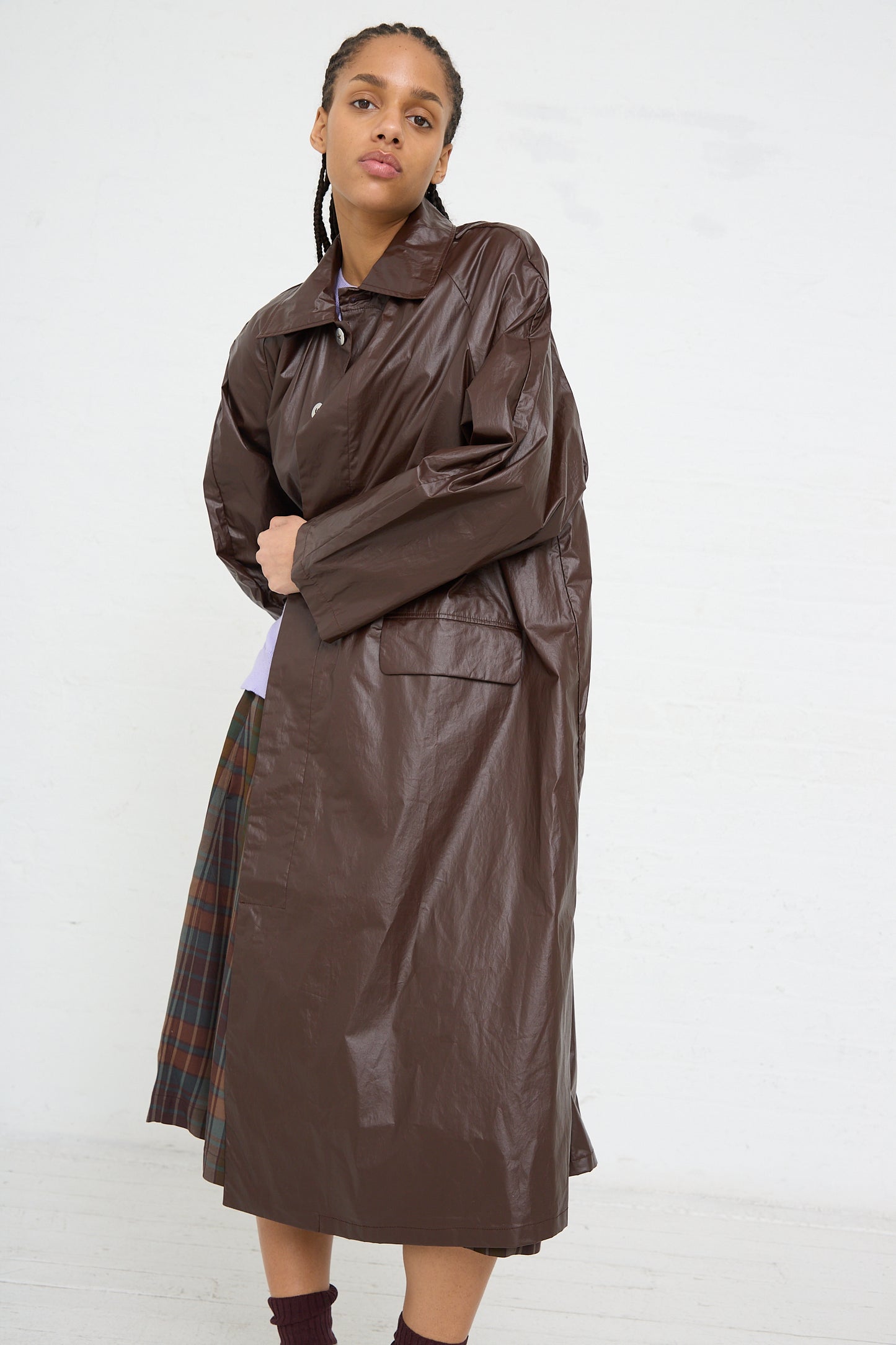 Woman modeling a water repellent long brown Cordera trench coat made in Spain.