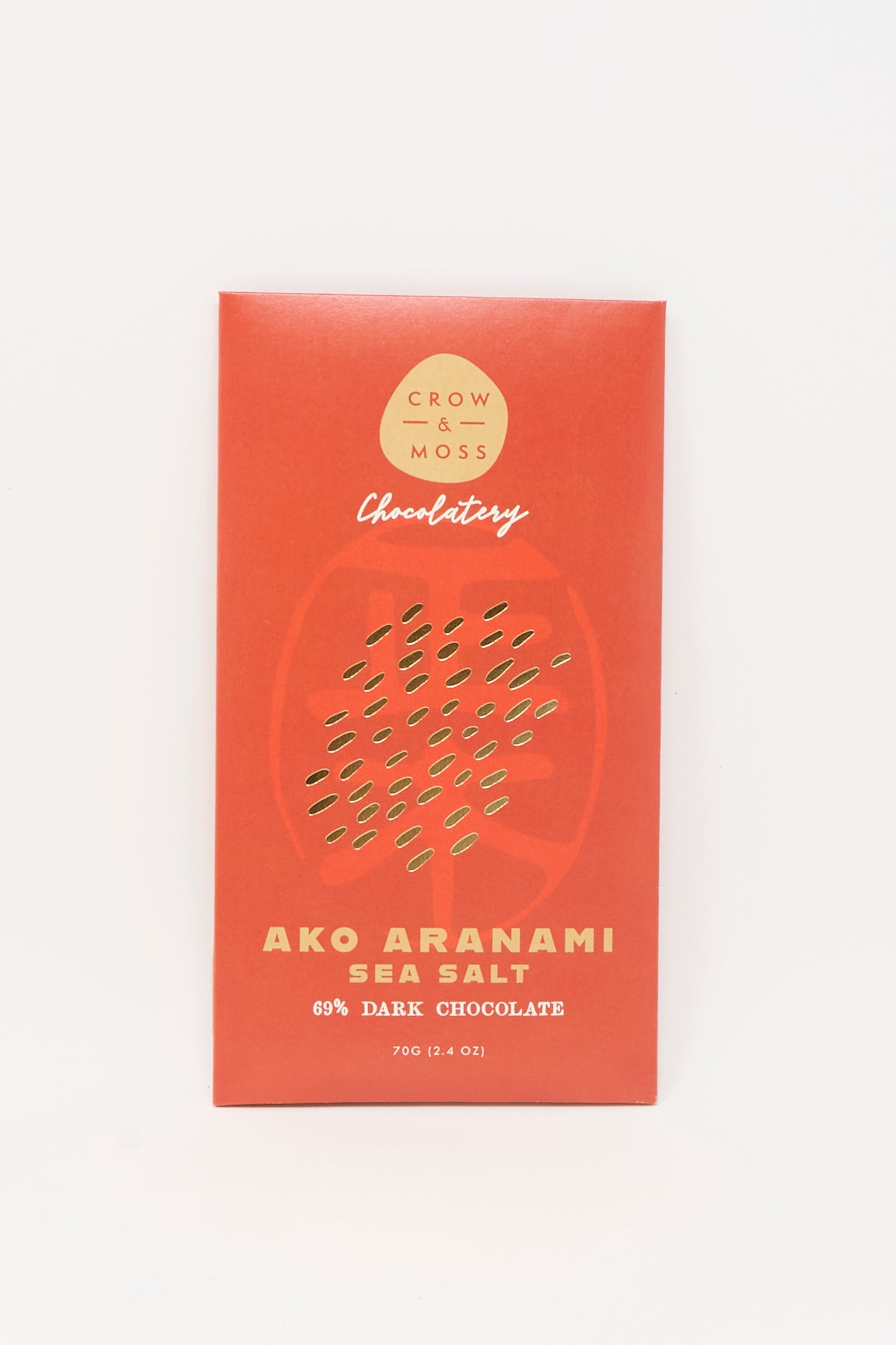 A red Crow & Moss wrapper displays "Ako Aranami Sea Salt Dark Chocolate" with a subtle abstract pattern.