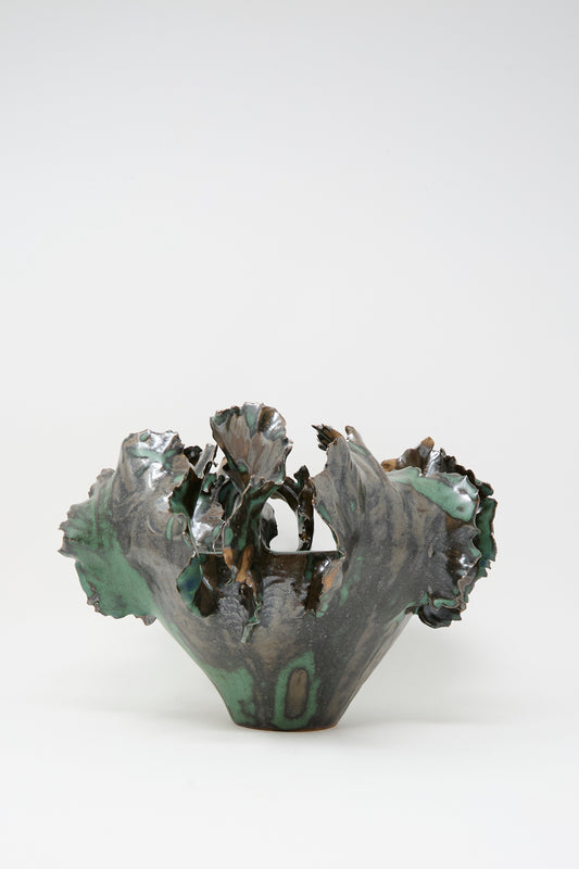 The Wild Petals Iris N.5 in Green by Dear You is a sculptural clay vase with an irregular, ruffled rim and organic form, featuring dark green and brown glazes over a white base.