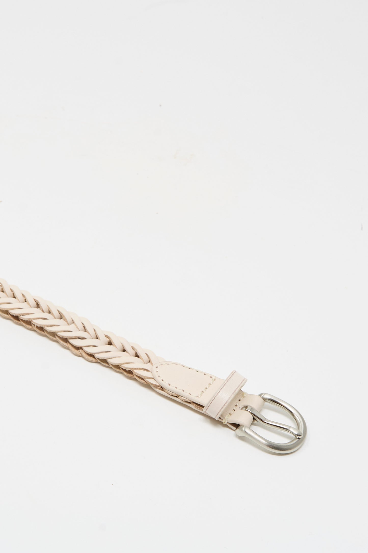 A close-up of the Dragon Diffusion Brass Buckle Single Link Belt in Sand, showcasing its handcrafted braided leather and bold brass buckle on a plain white background.