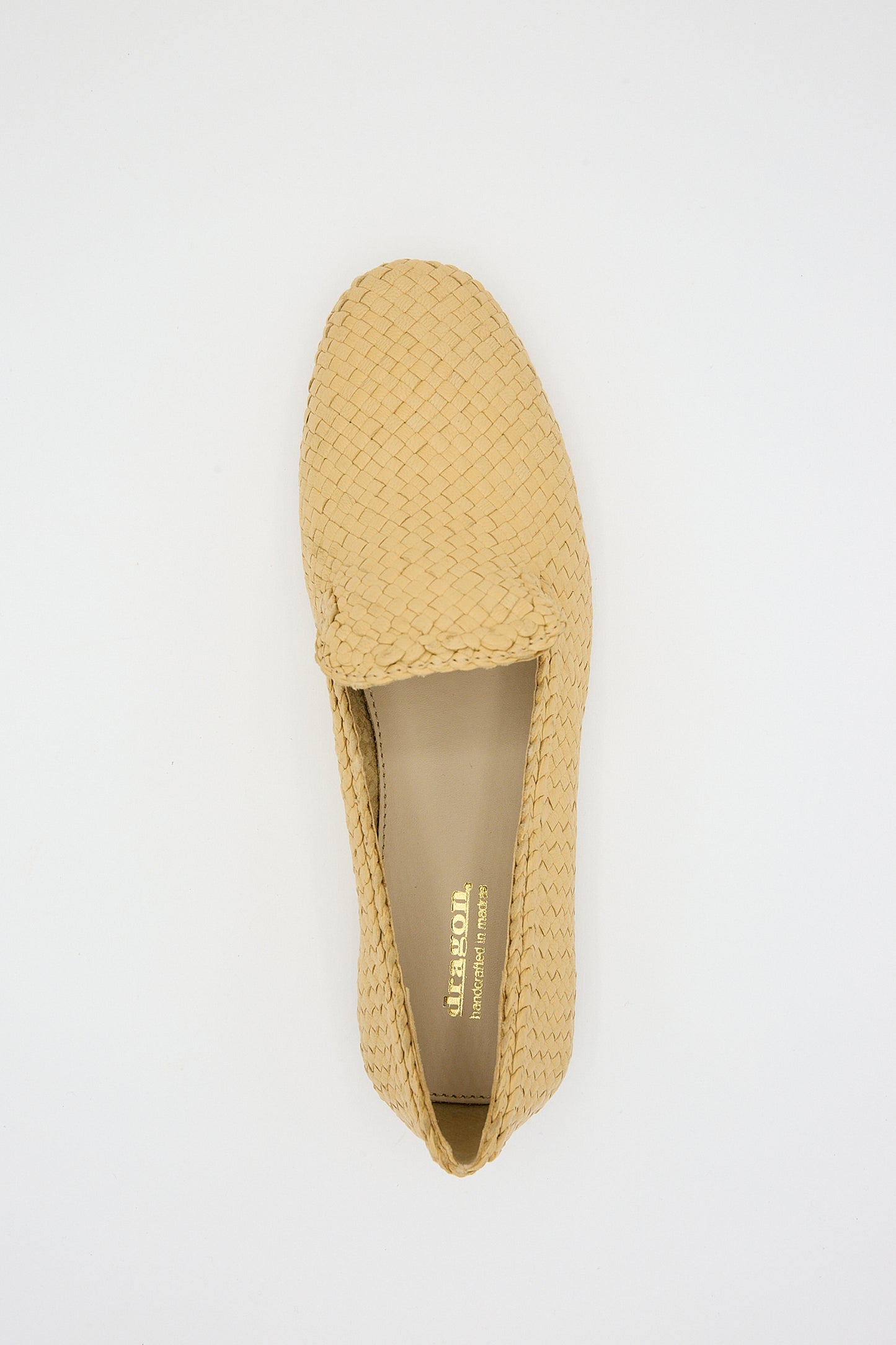 Handwoven goatskin leather Damas Slipper in Natural by Dragon Diffusion on a white background. Overhead view.