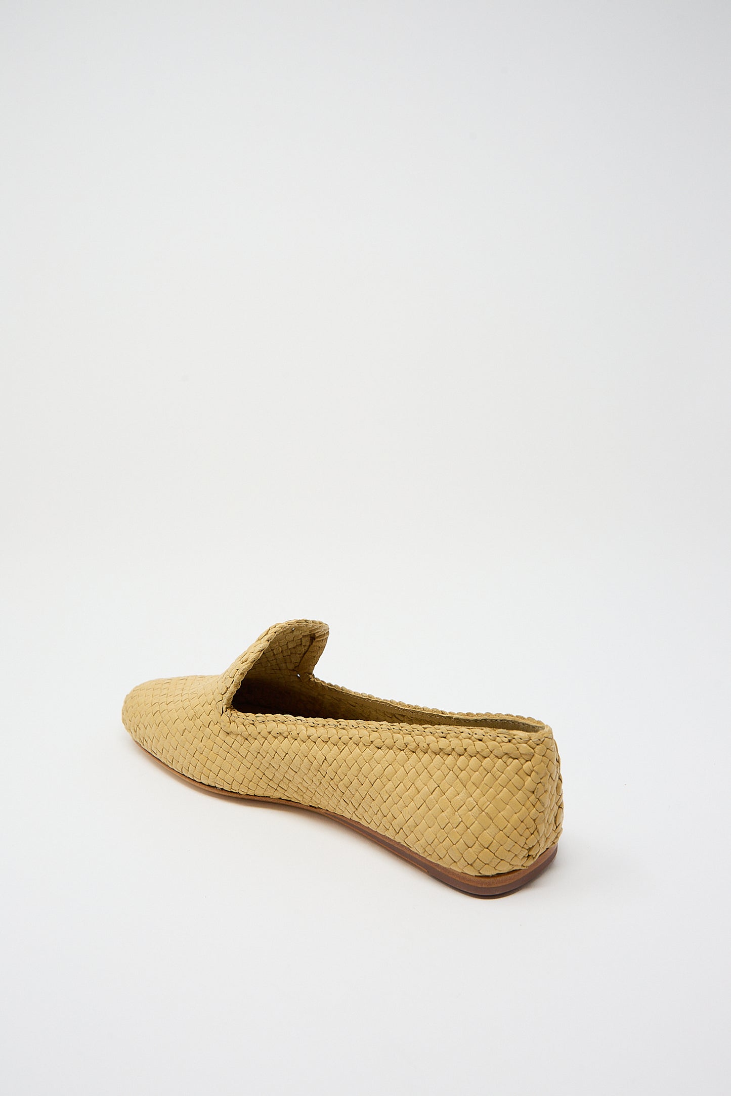 Woven beige Damas Slipper in Natural made of goatskin leather on a white background by Dragon Diffusion.