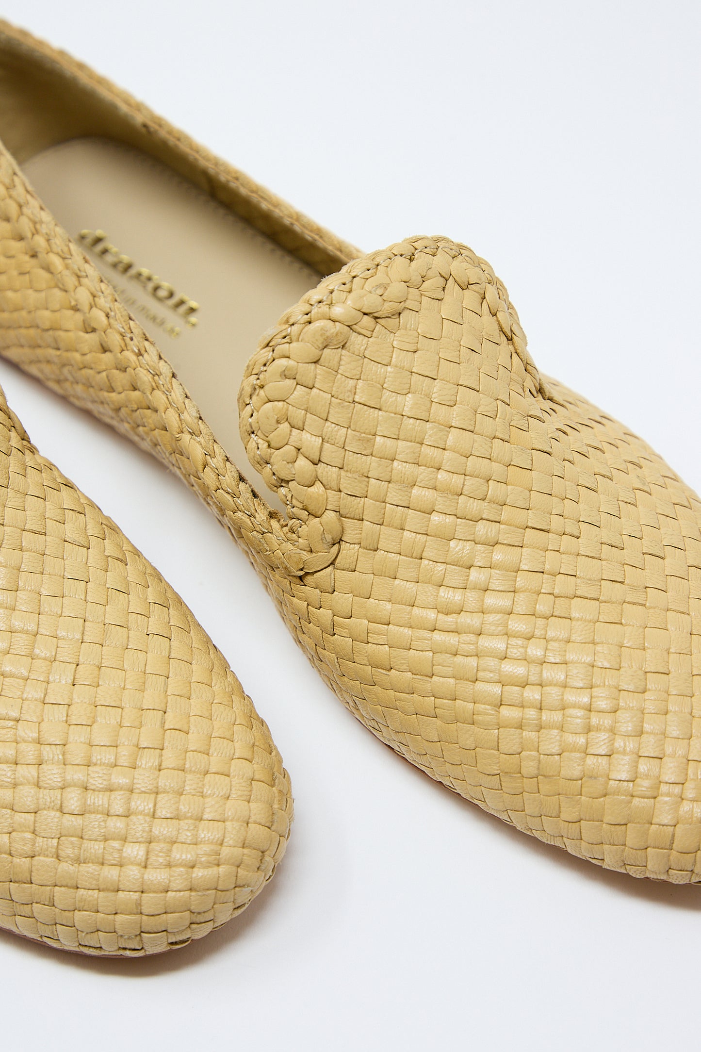 A close-up of a pair of Dragon Diffusion Damas Slipper in Natural handwoven tan goatskin leather loafers against a white background.
