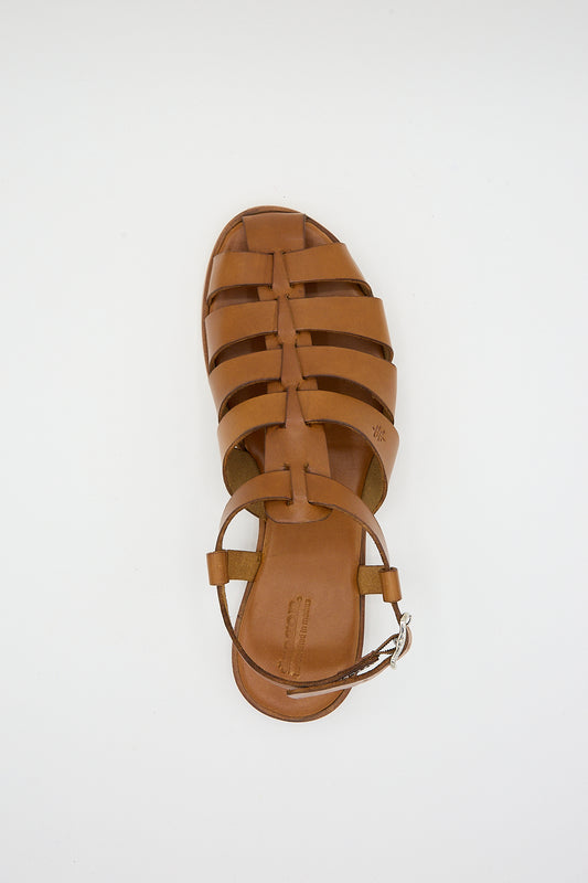 Top view of a single tan Pescador sandal by Dragon Diffusion on a white background.