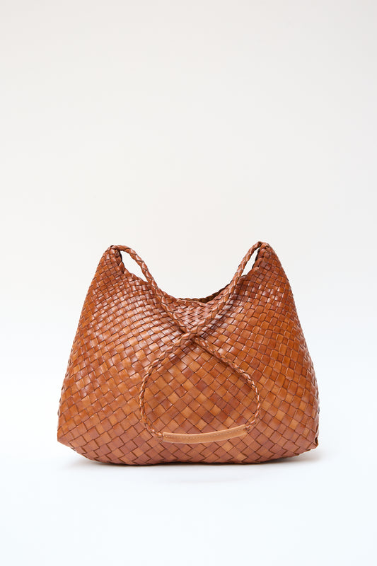 A brown handwoven leather tote bag with a circular pattern in the center, displayed against a light backdrop, Dragon Diffusion Santa Rosa in Tan.