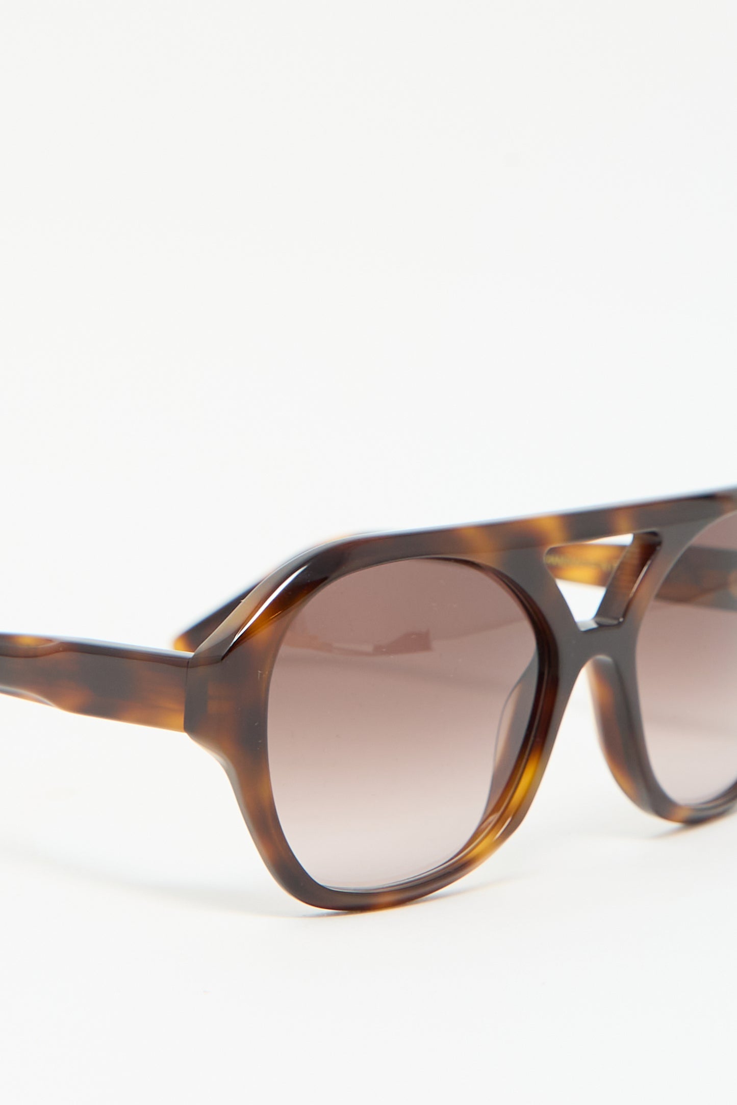 Close-up of Chiyo Sunglasses in Good Luck by Eva Masaki, made from Italian acetate with a tortoiseshell design and round lenses featuring a thick frame that provides 100% UV protection.