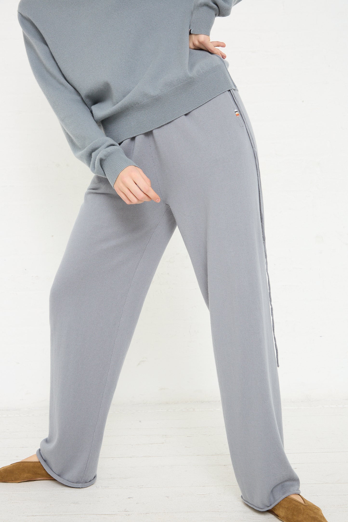 The model is wearing No. 278 Judo Pant in Sage with a drawstring waist and an Extreme Cashmere sweater.