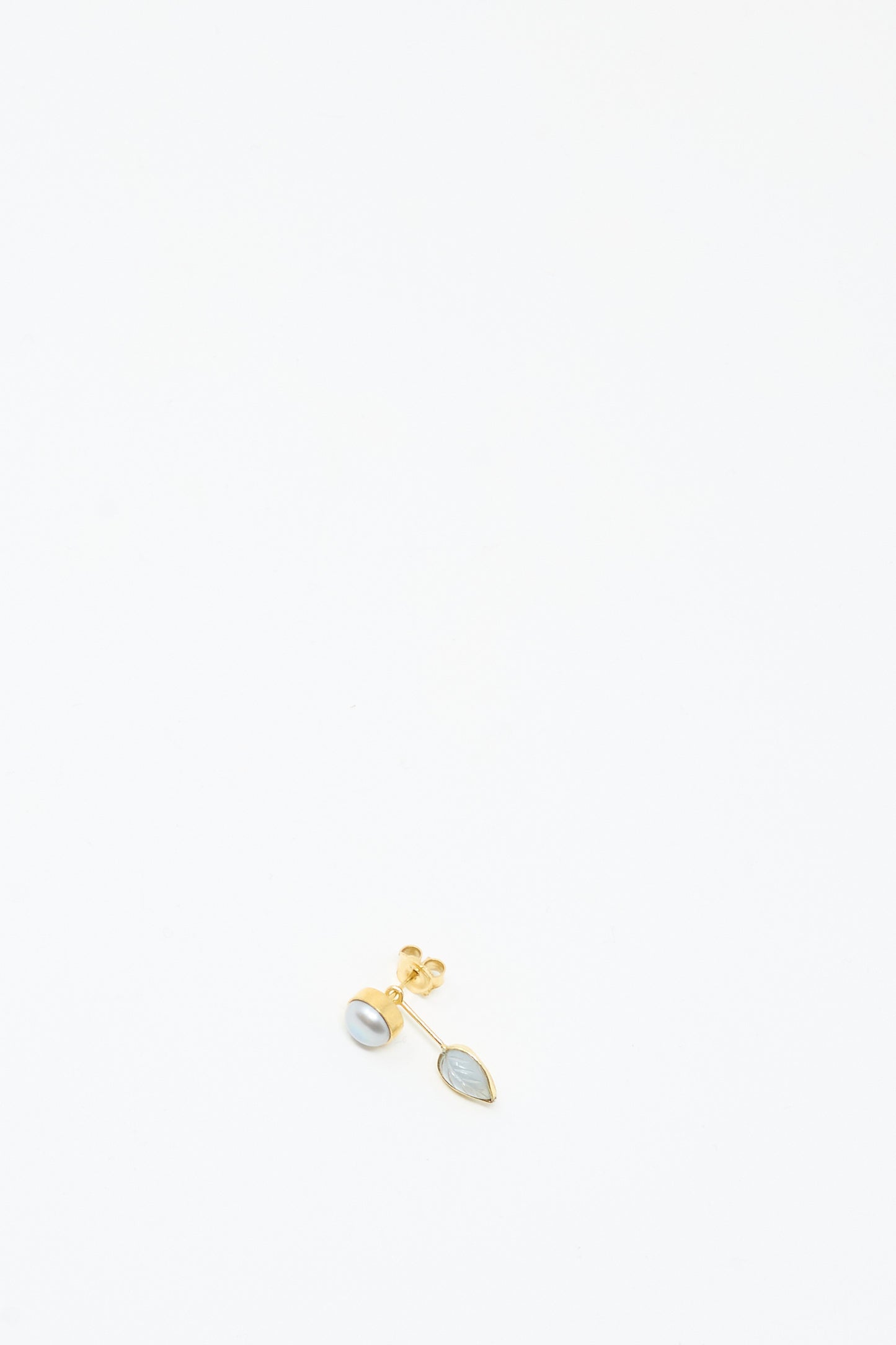 The Grainne Morton Detachable Drop Earring in Pearl and Leaf features a gold pearl stud and a marquise blue stone, both handmade from 18K gold-plated silver, shown on a plain white background.
