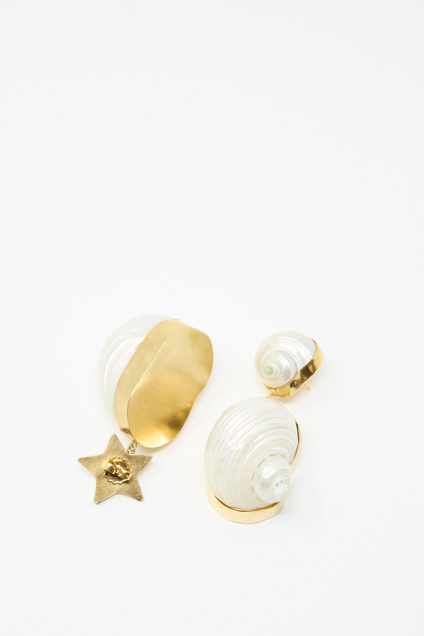 The Grainne Morton Moon and Star Shell Drop Earrings feature three 18K gold plated, mother of pearl shell-shaped designs with a gold star charm, displayed on white.