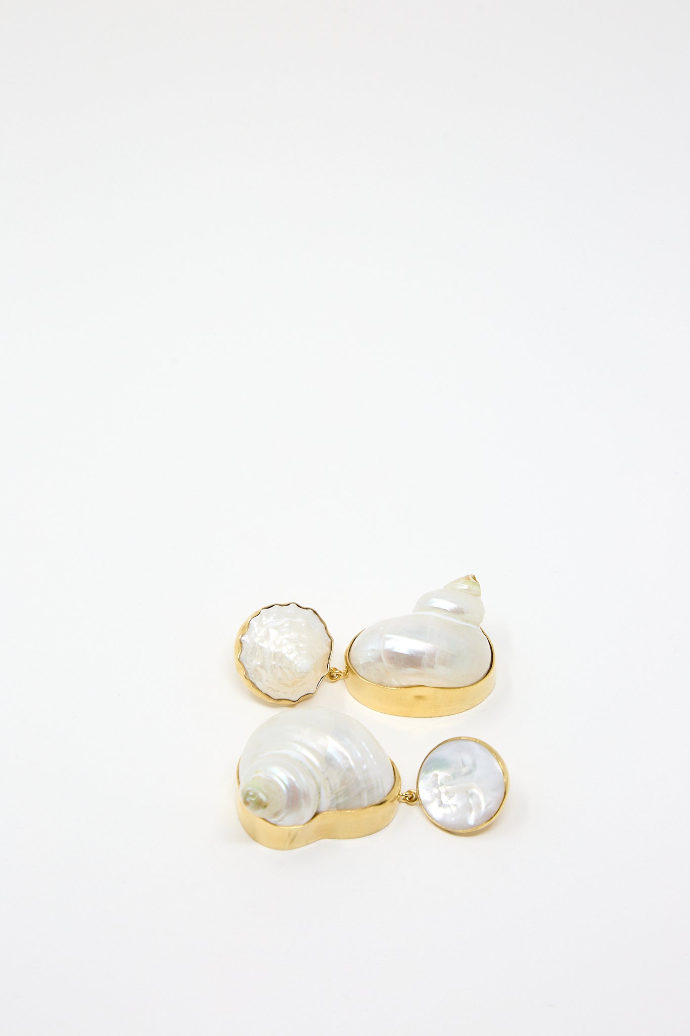 A pair of Grainne Morton Moon and Star Shell Drop Earrings, made of 18K gold-plated silver and Mother of Pearl, on a white surface.