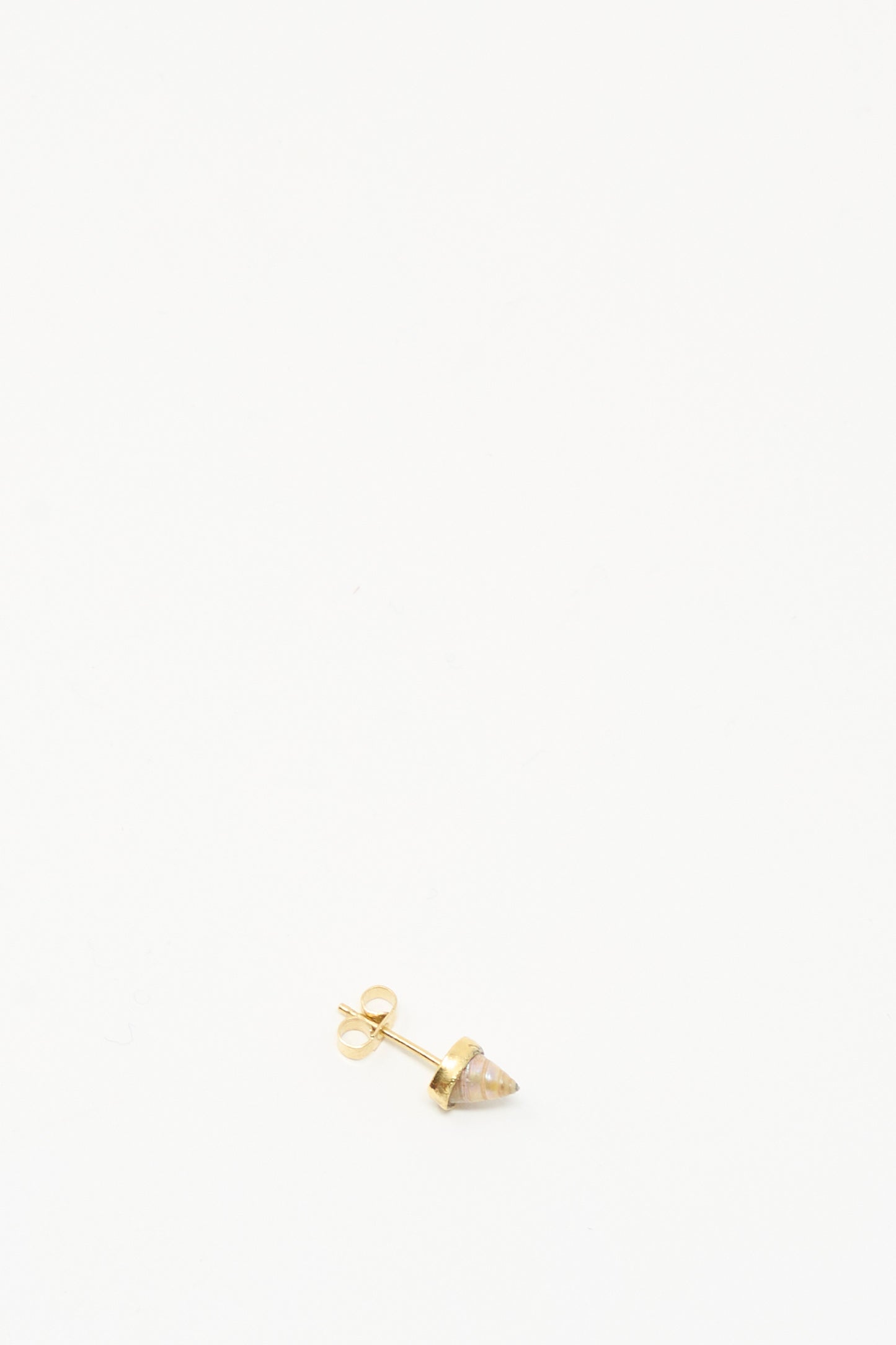 A single handmade Stud Earring in Shell by Grainne Morton, featuring a small conical stone and crafted from ethically sourced materials, is displayed on a plain white background.